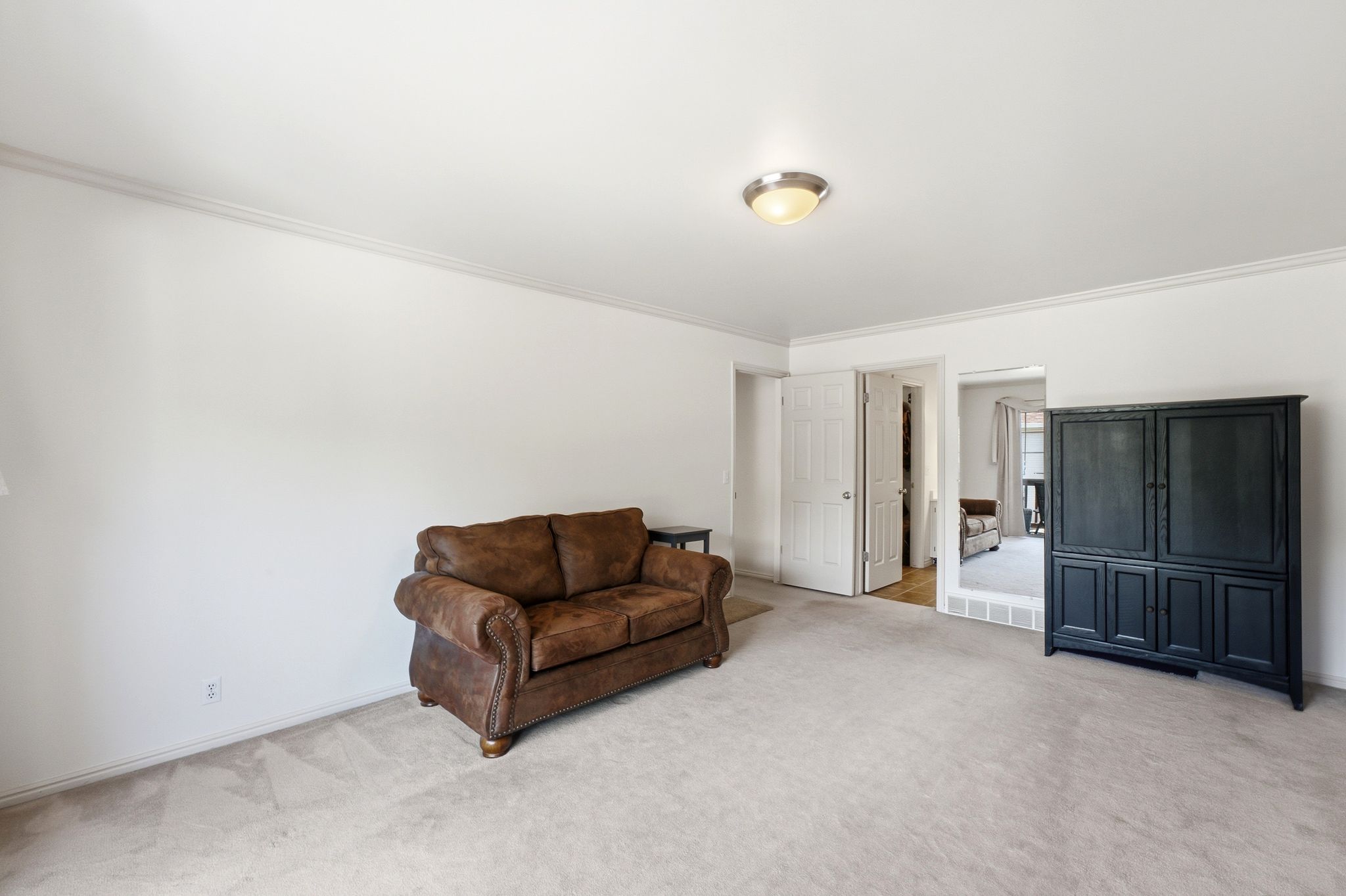 Spacious interior room with light-toned wall paint and crown molding