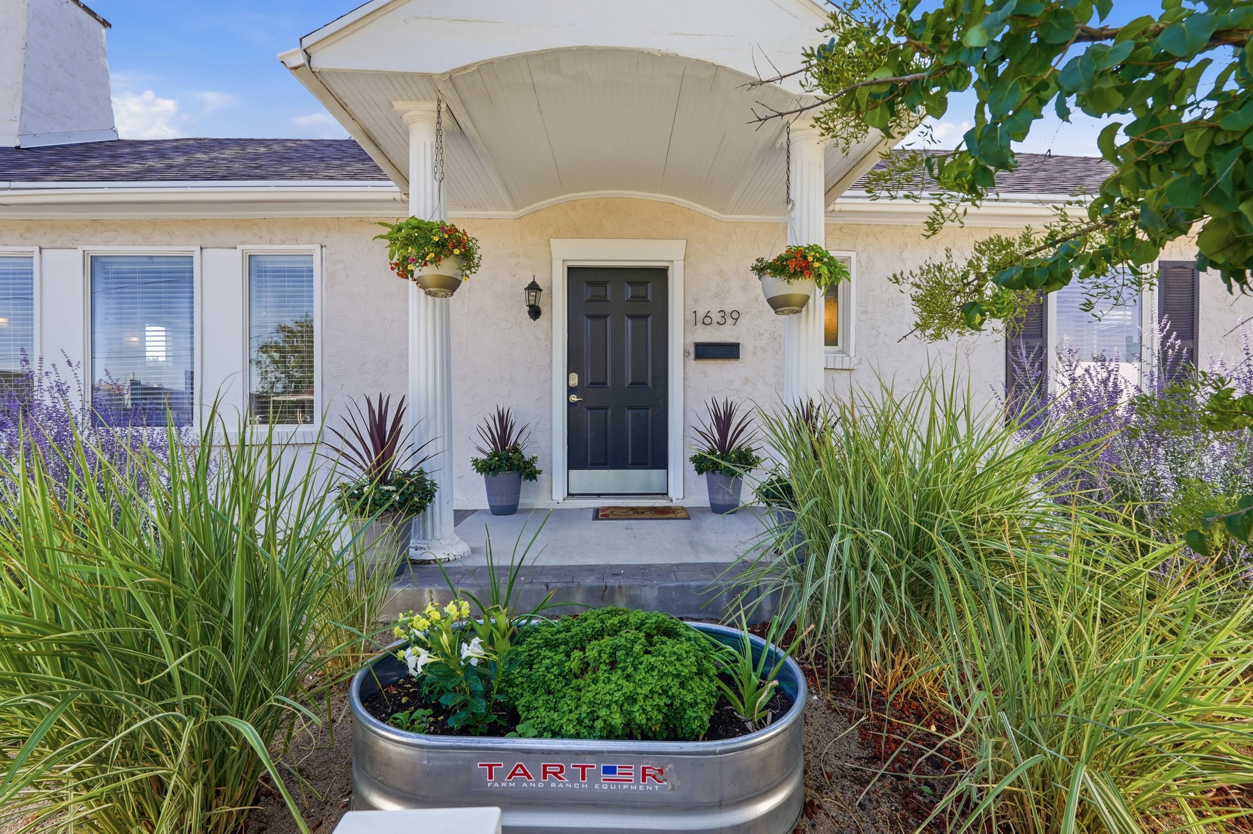 Welcoming front entrance with a dark paneled door and white trim