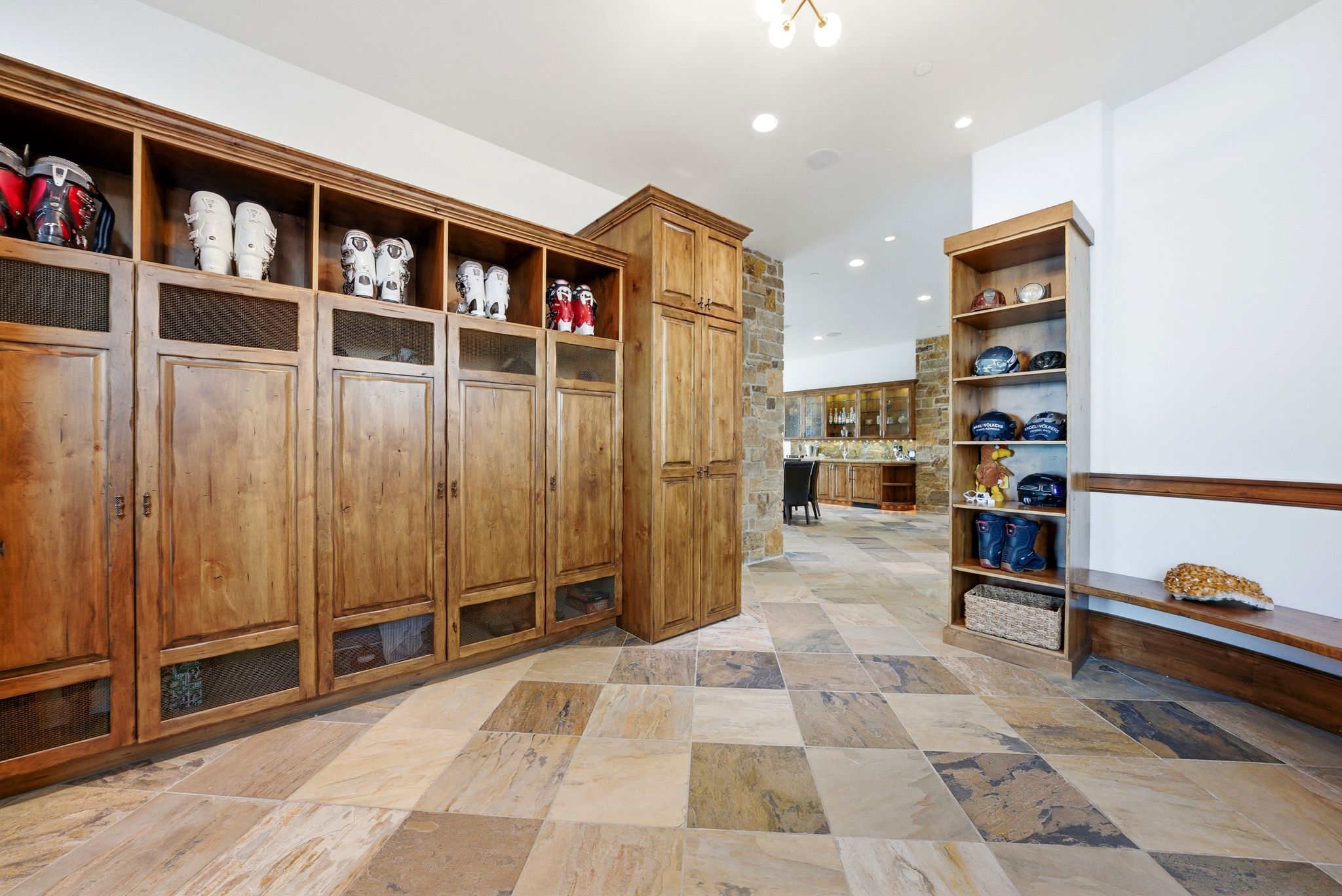 Custom built-in wood cabinetry with glass-fronted upper storage and lower compartments