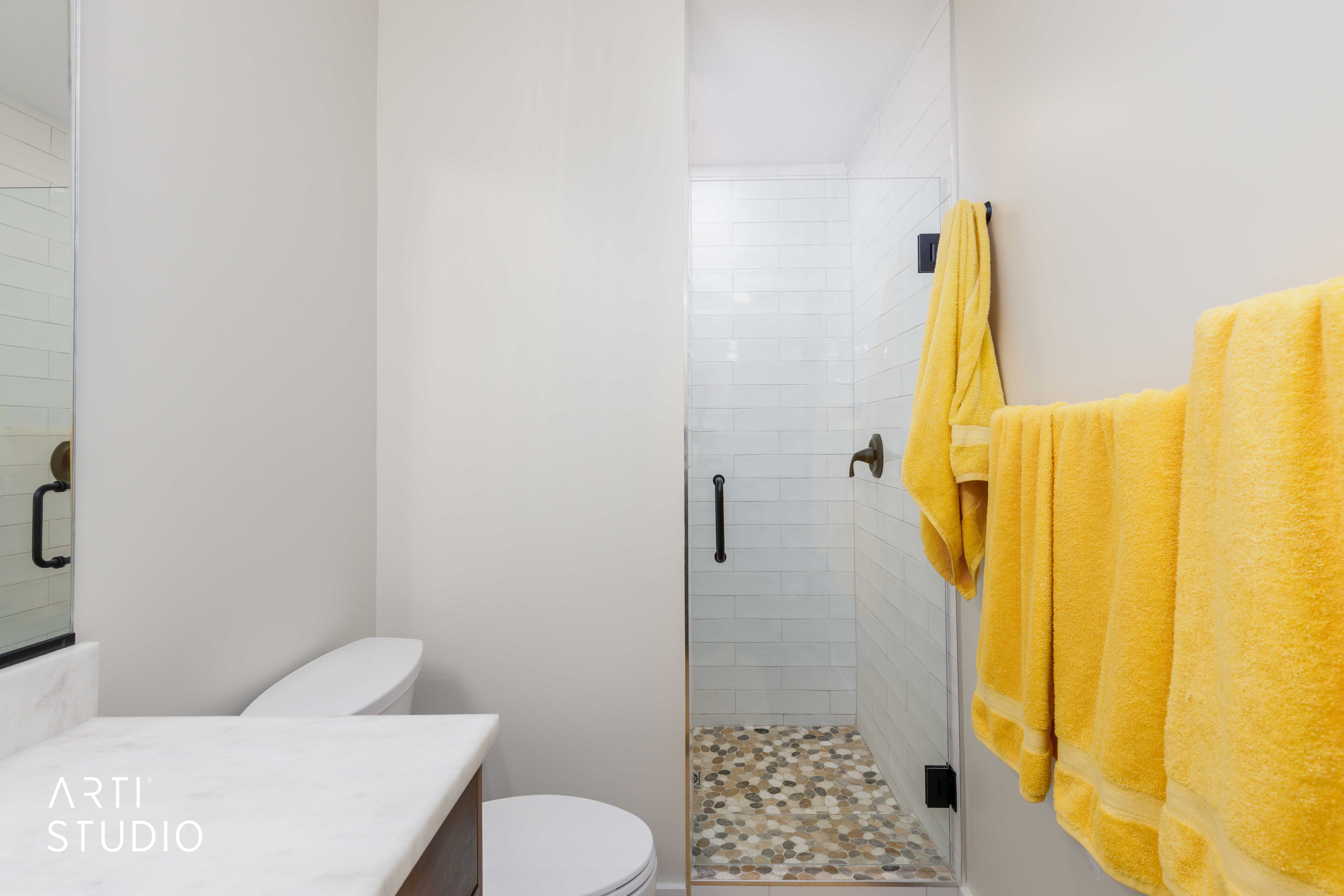 Shower with clear glass enclosure and subway tile surround