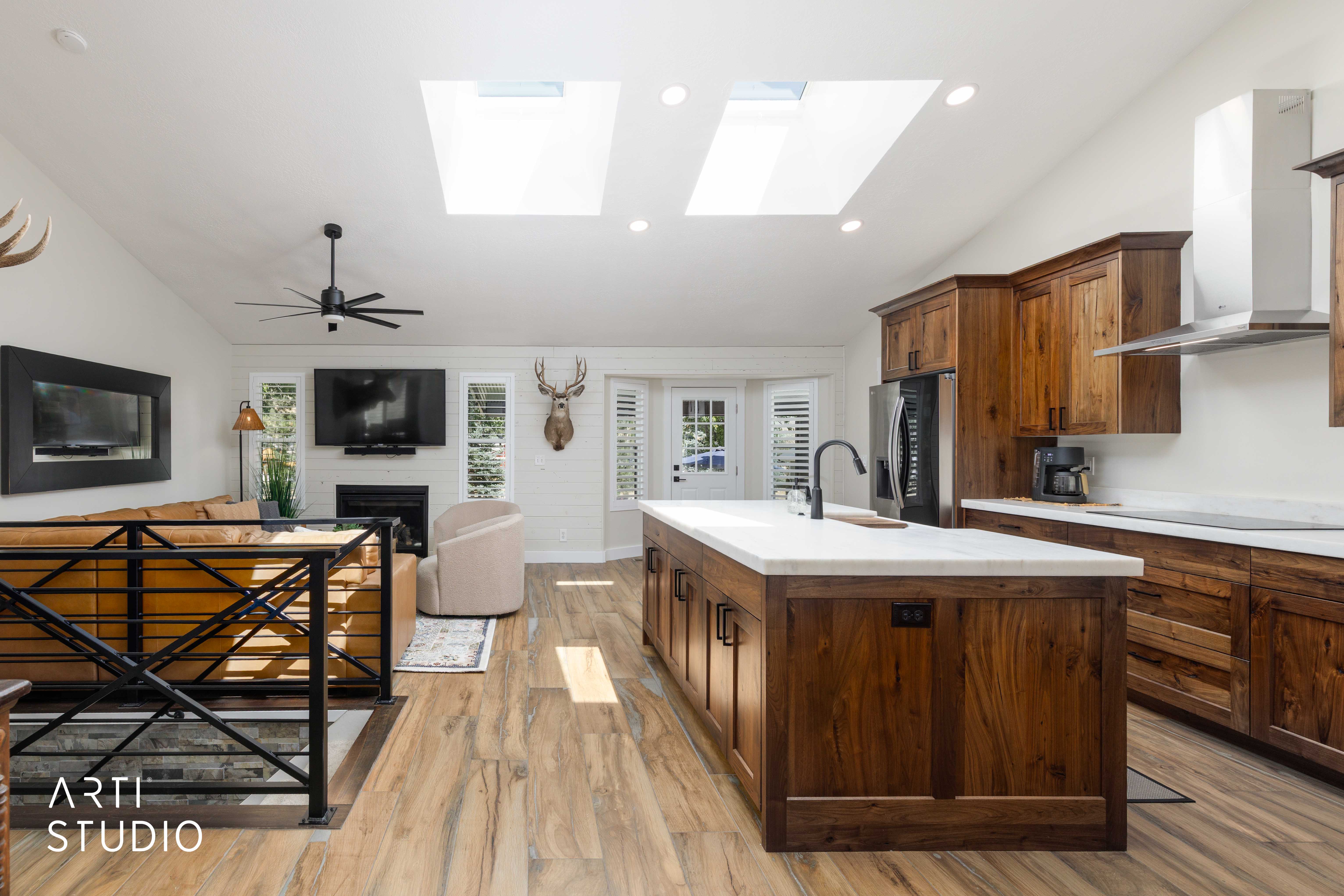 Open-concept living space with vaulted ceilings and skylights