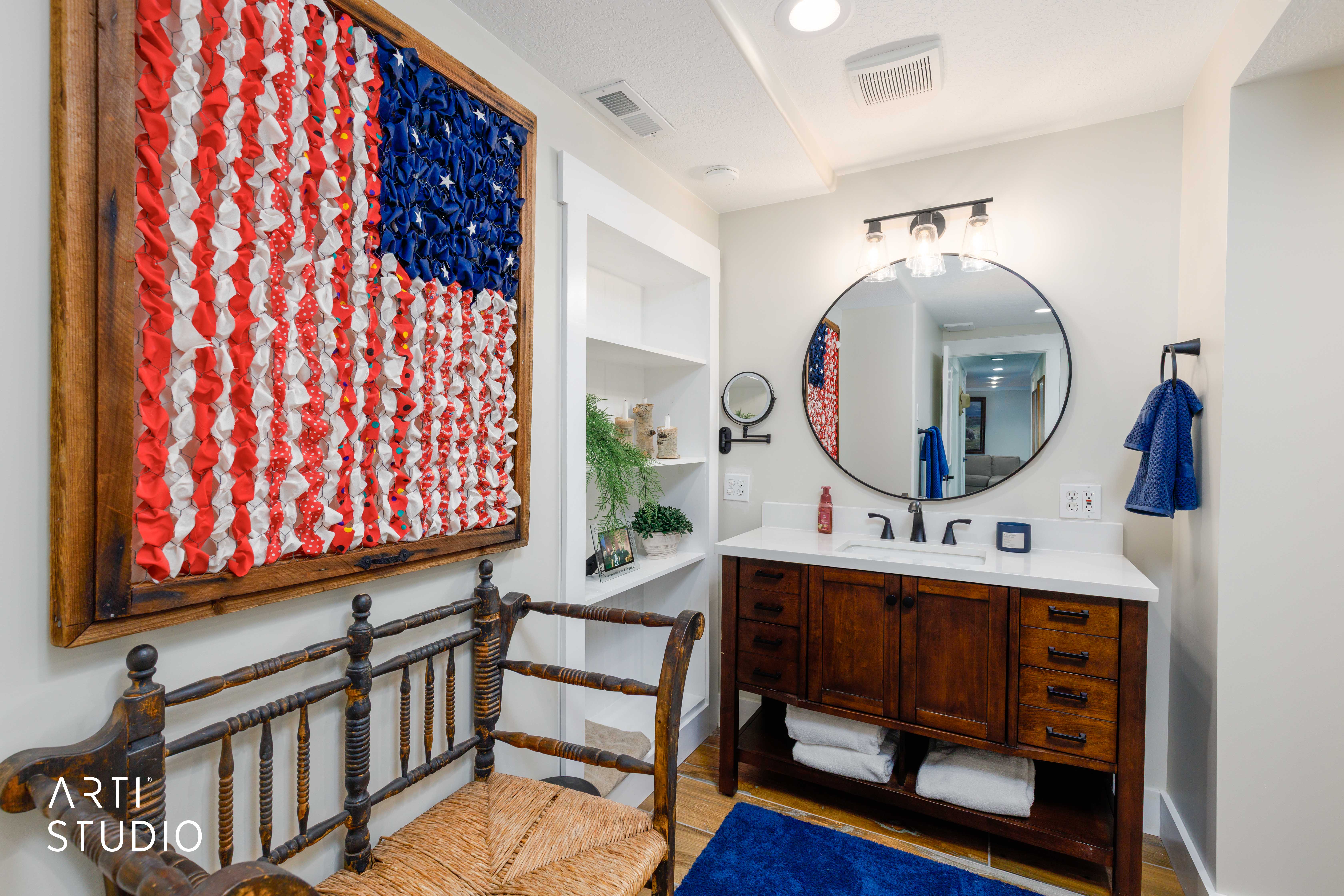Bathroom featuring a wood-finish vanity with a white countertop and an undermount sink