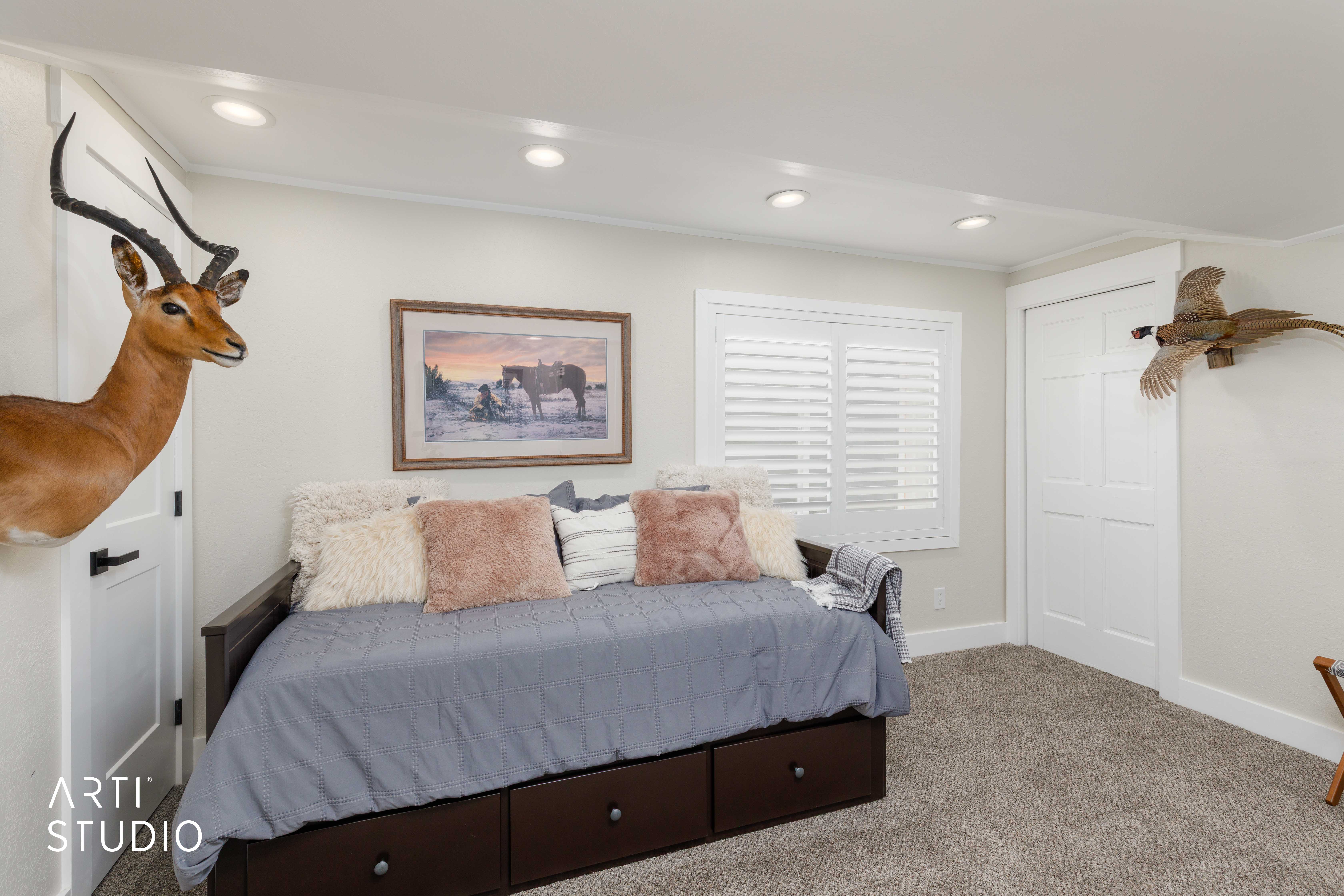 Plush carpeting, recessed lighting, and white plantation shutters complement the neutral wall tones