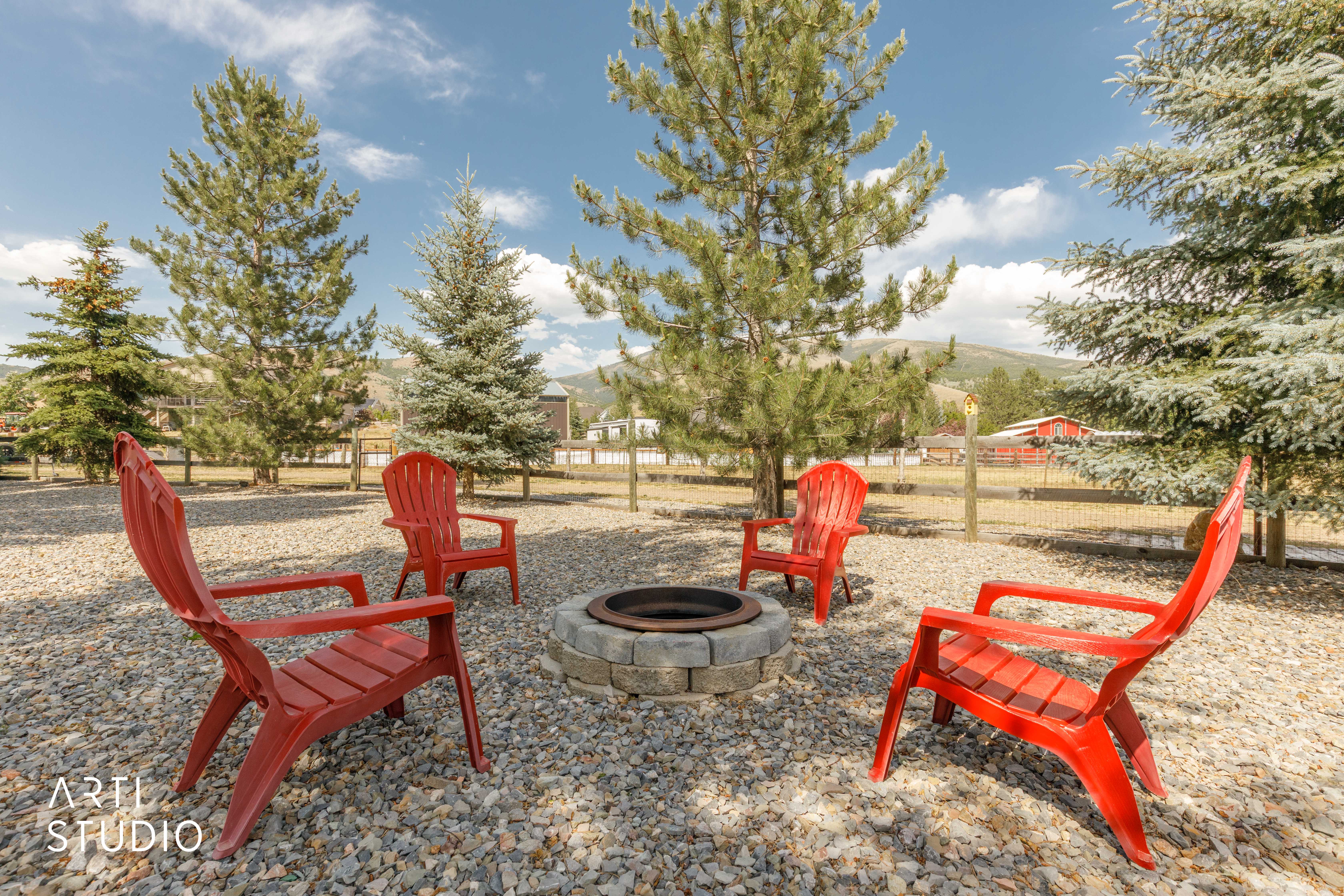 Gravel outdoor area featuring a circular stone fire pit
