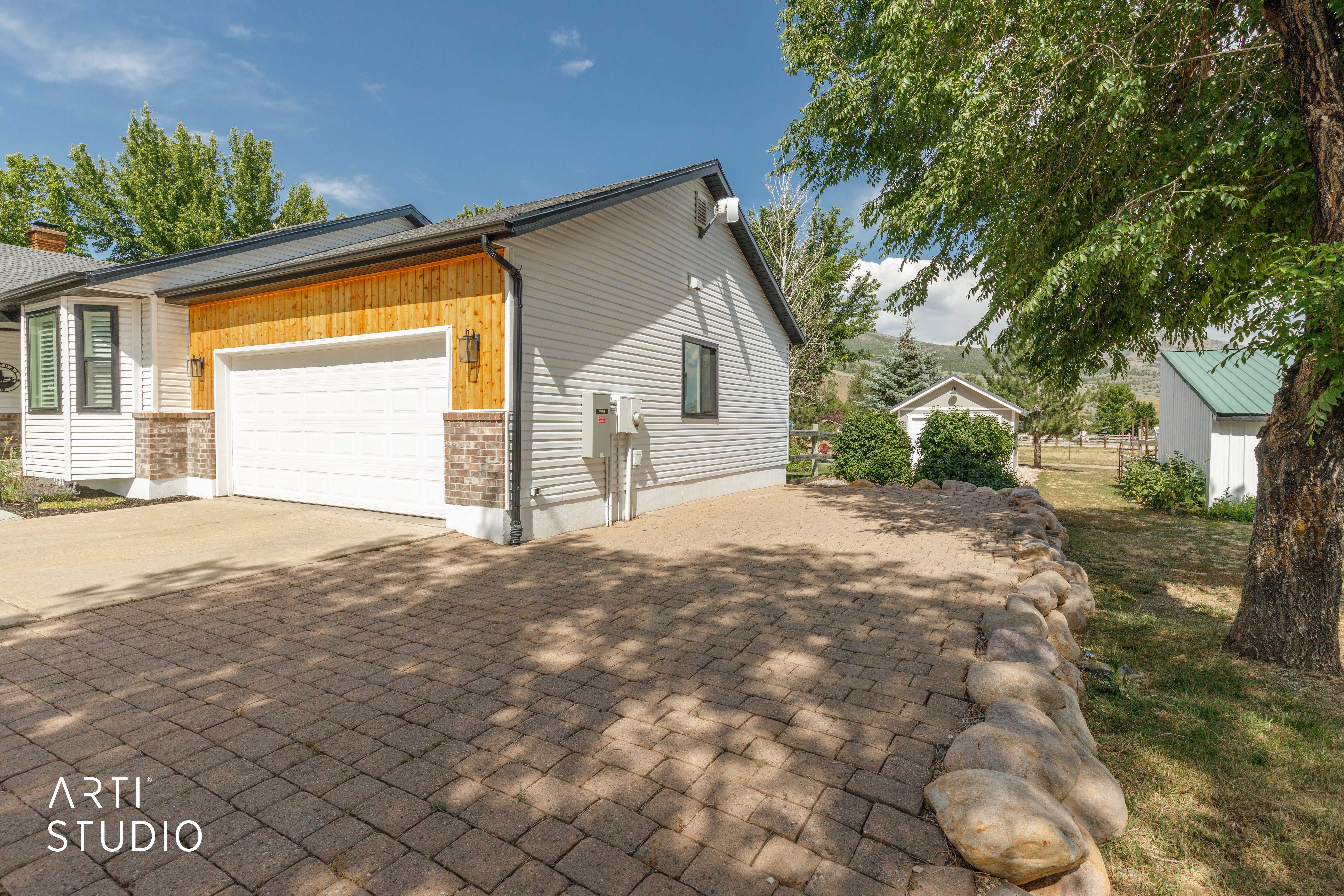 Paved driveway with stone retaining wall