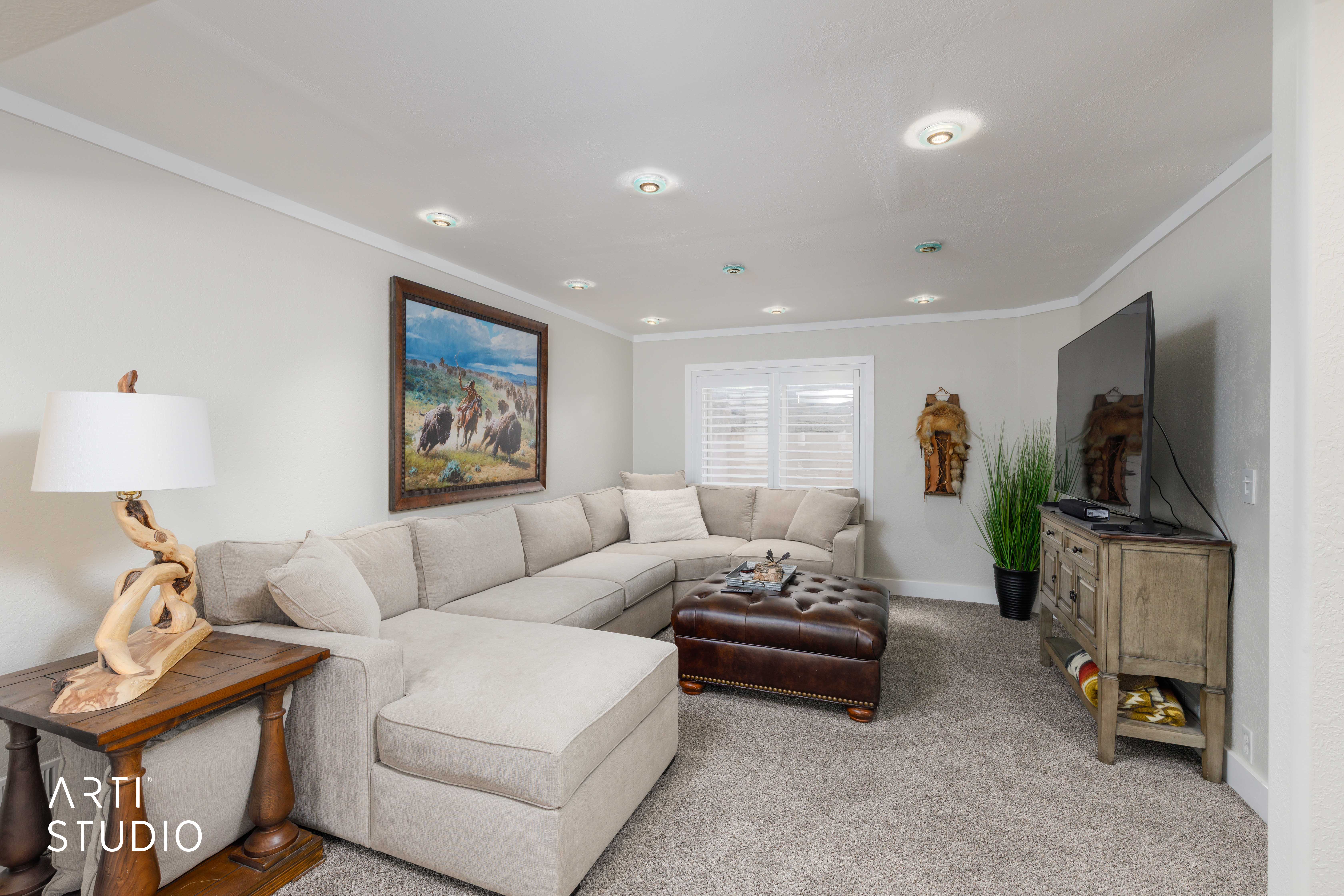 Carpeted living area featuring recessed lighting and white crown molding