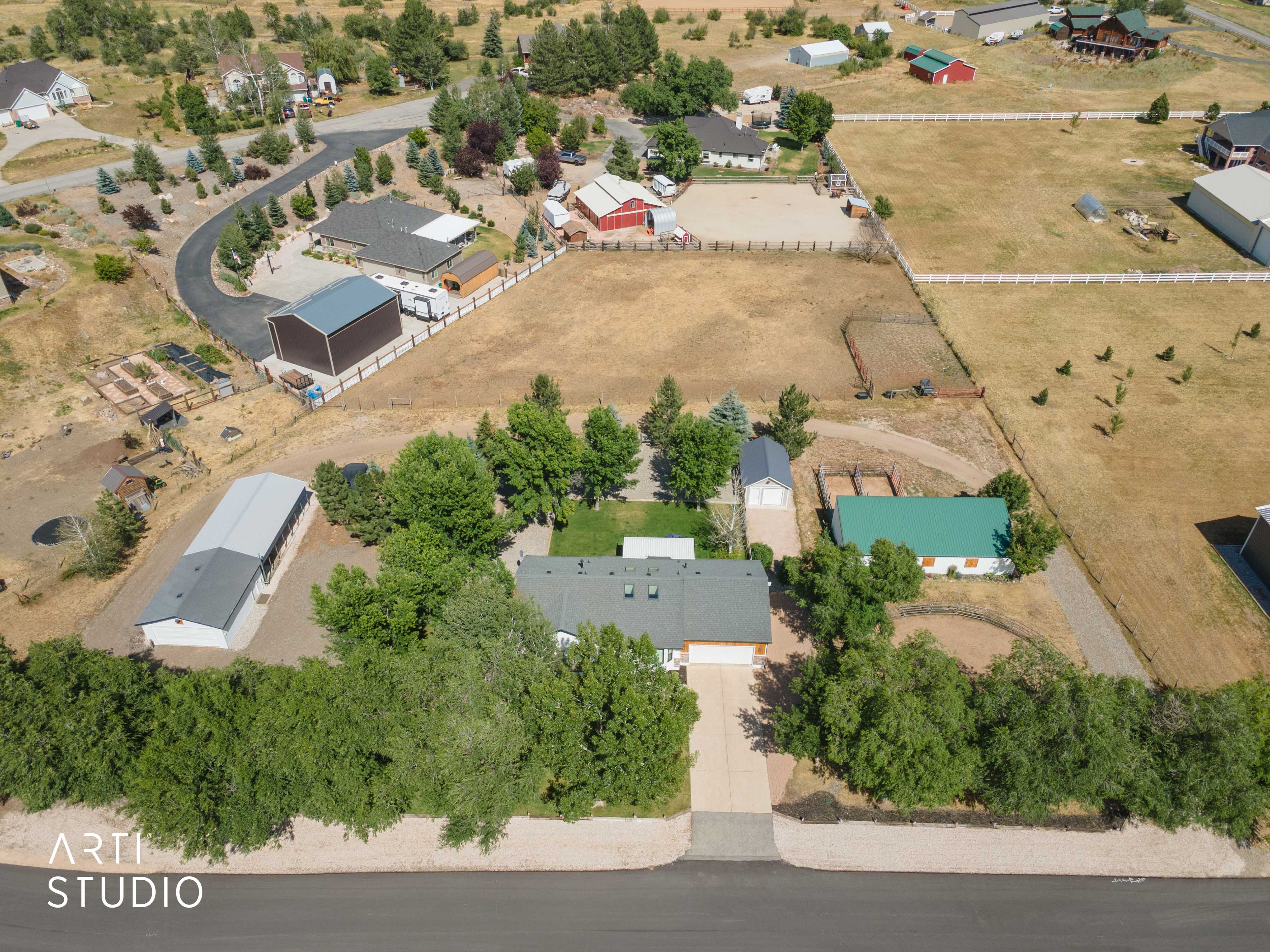 Expansive property featuring a main residence, multiple outbuildings, and extensive open land
