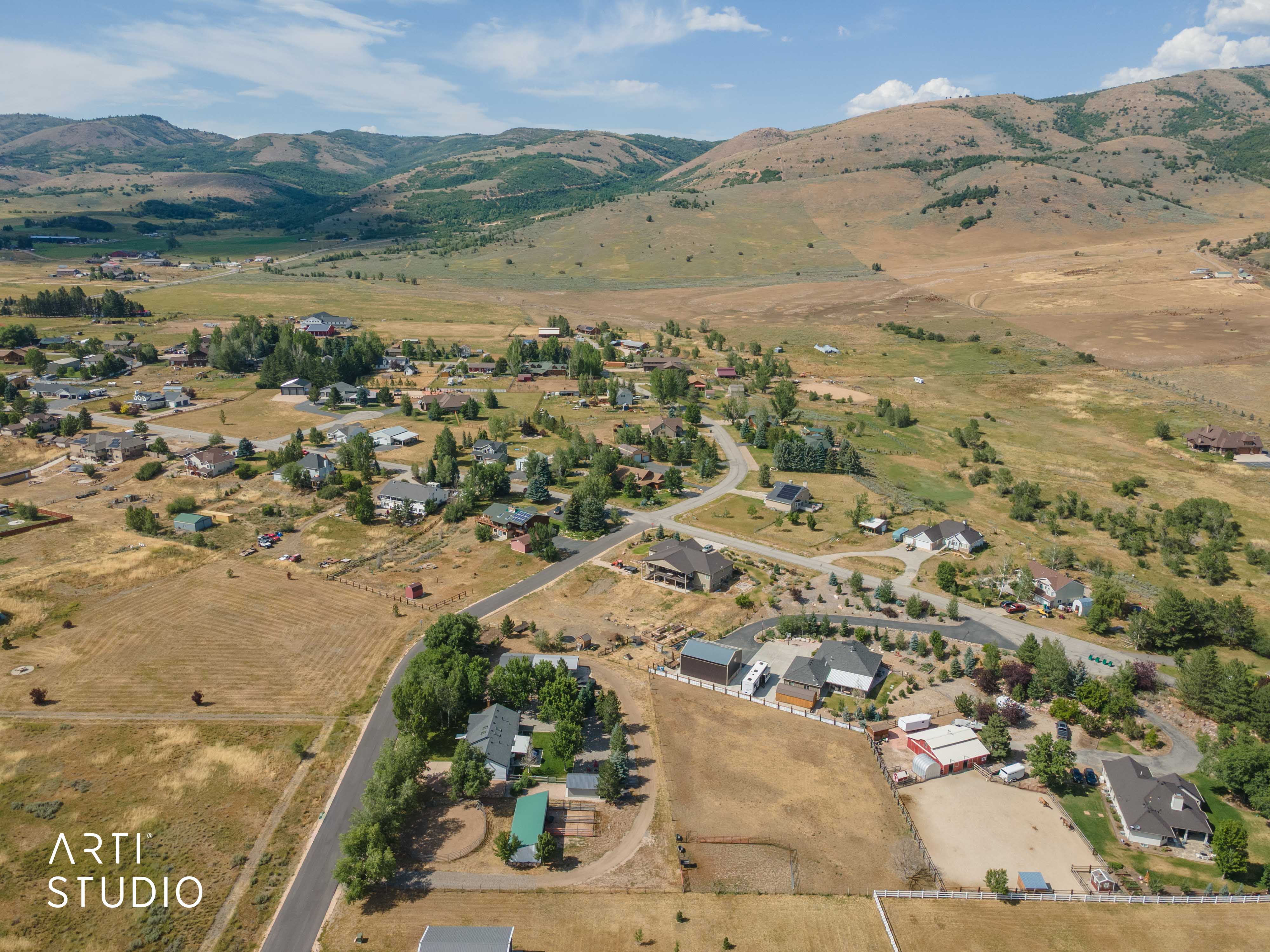 Aerial perspective showcasing residential properties within a mountainous landscape