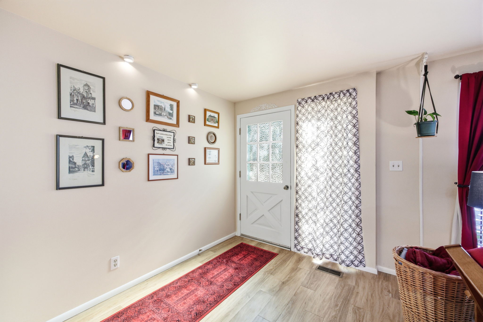 Entryway featuring wood-finish flooring, a glass-paneled door with an X-brace design, and recessed ceiling lighting