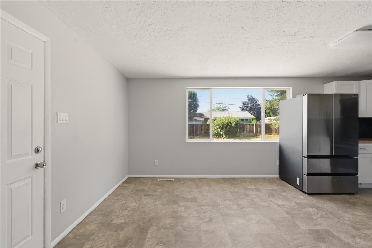 Light grey walls complement the wood-finish flooring