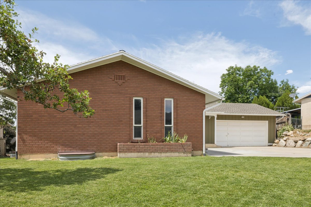 Brick exterior featuring a gabled roofline and two elongated windows