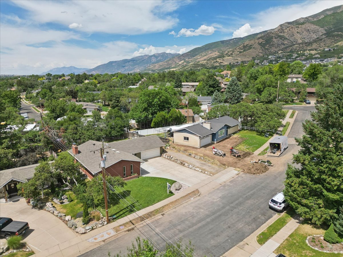 Aerial perspective showcasing a residential neighborhood with mountain backdrop