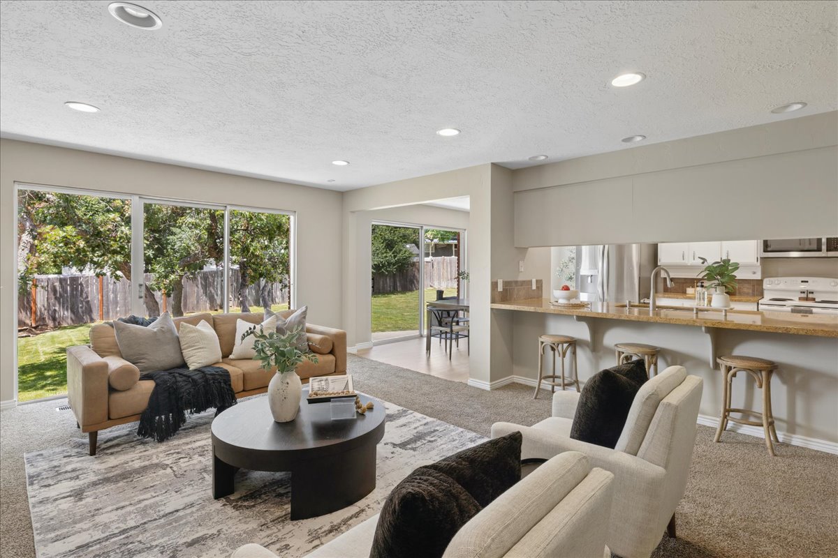Open-concept living area featuring recessed lighting and sliding glass doors to the backyard