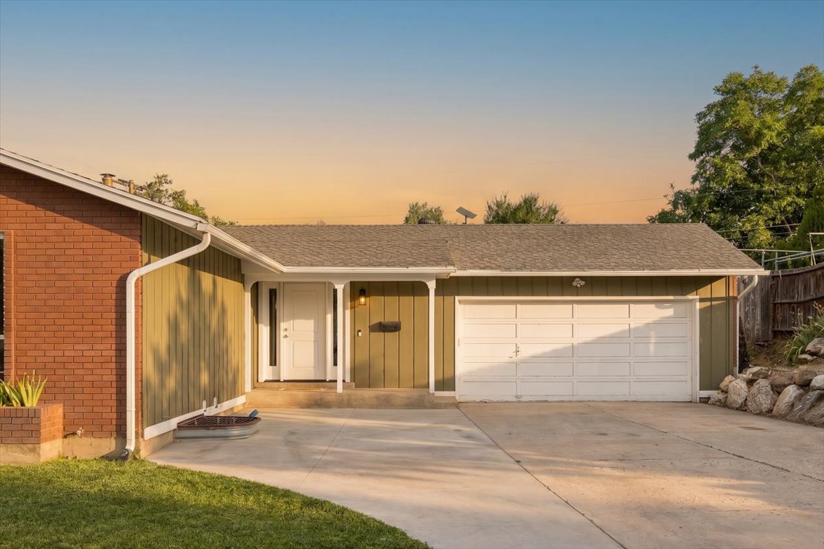 Ranch-style exterior with brick and vertical panel siding