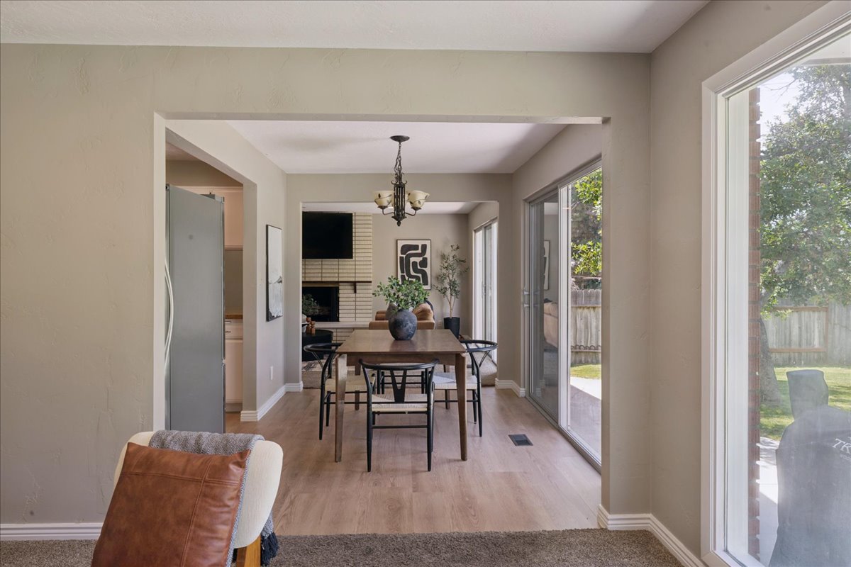 Dining area featuring wood-finish flooring and a decorative chandelier