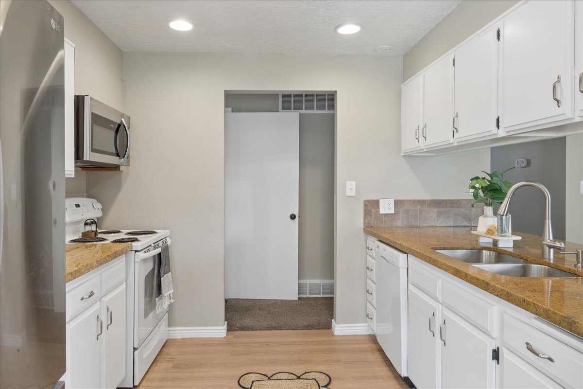 Kitchen featuring wood-finish flooring and recessed lighting