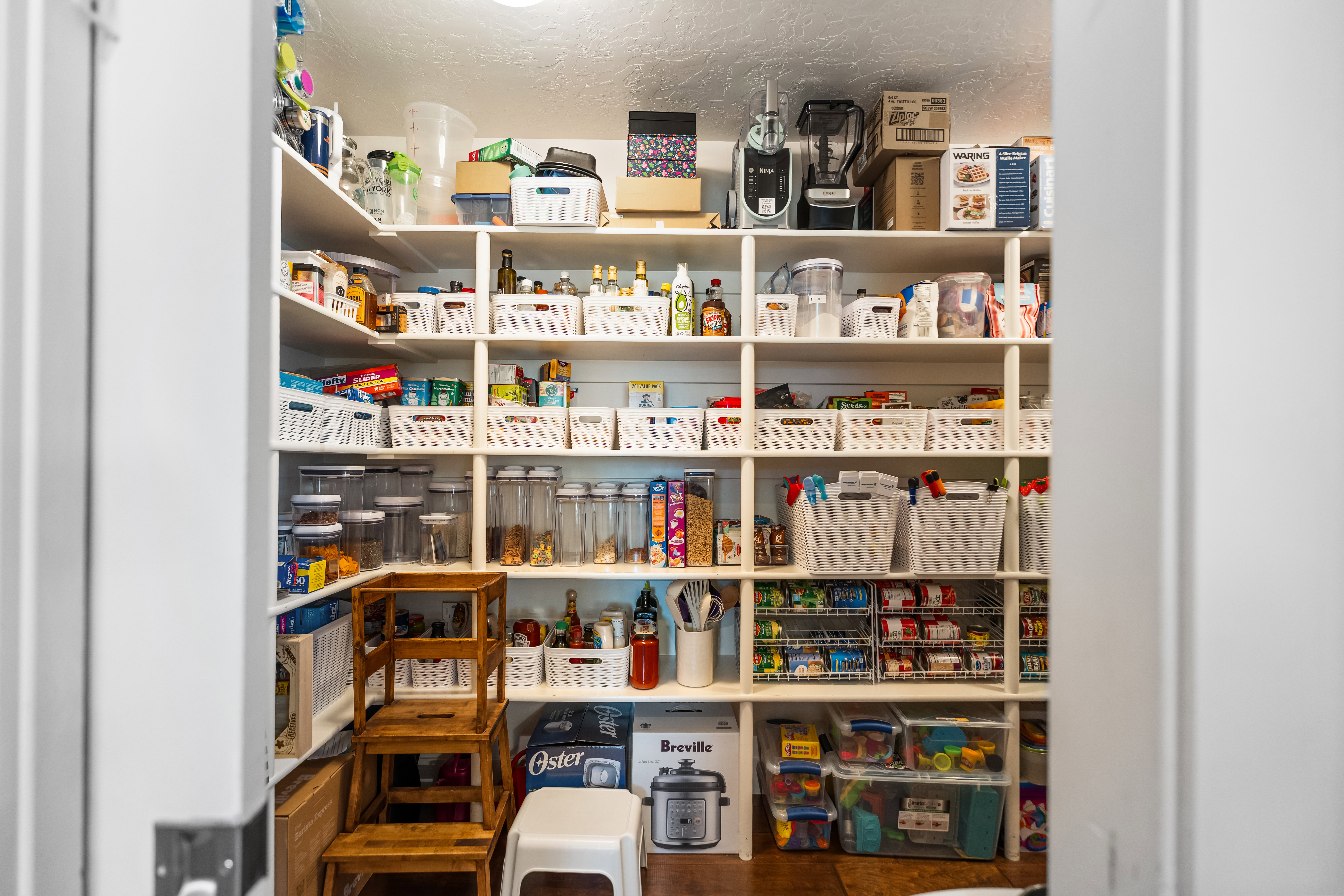 Spacious pantry featuring extensive built-in shelving, providing abundant storage