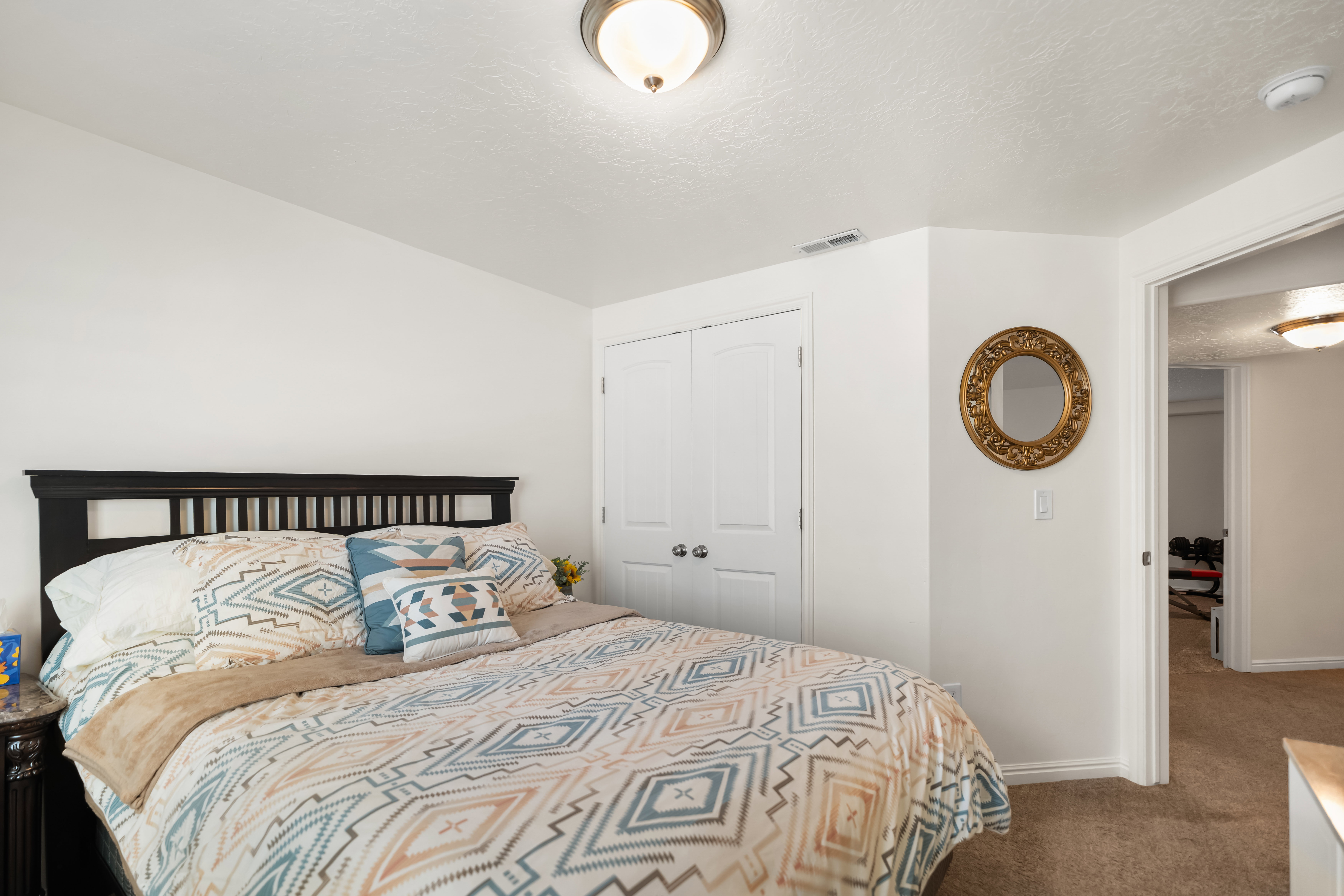 White walls and light-colored carpet provide a neutral palette