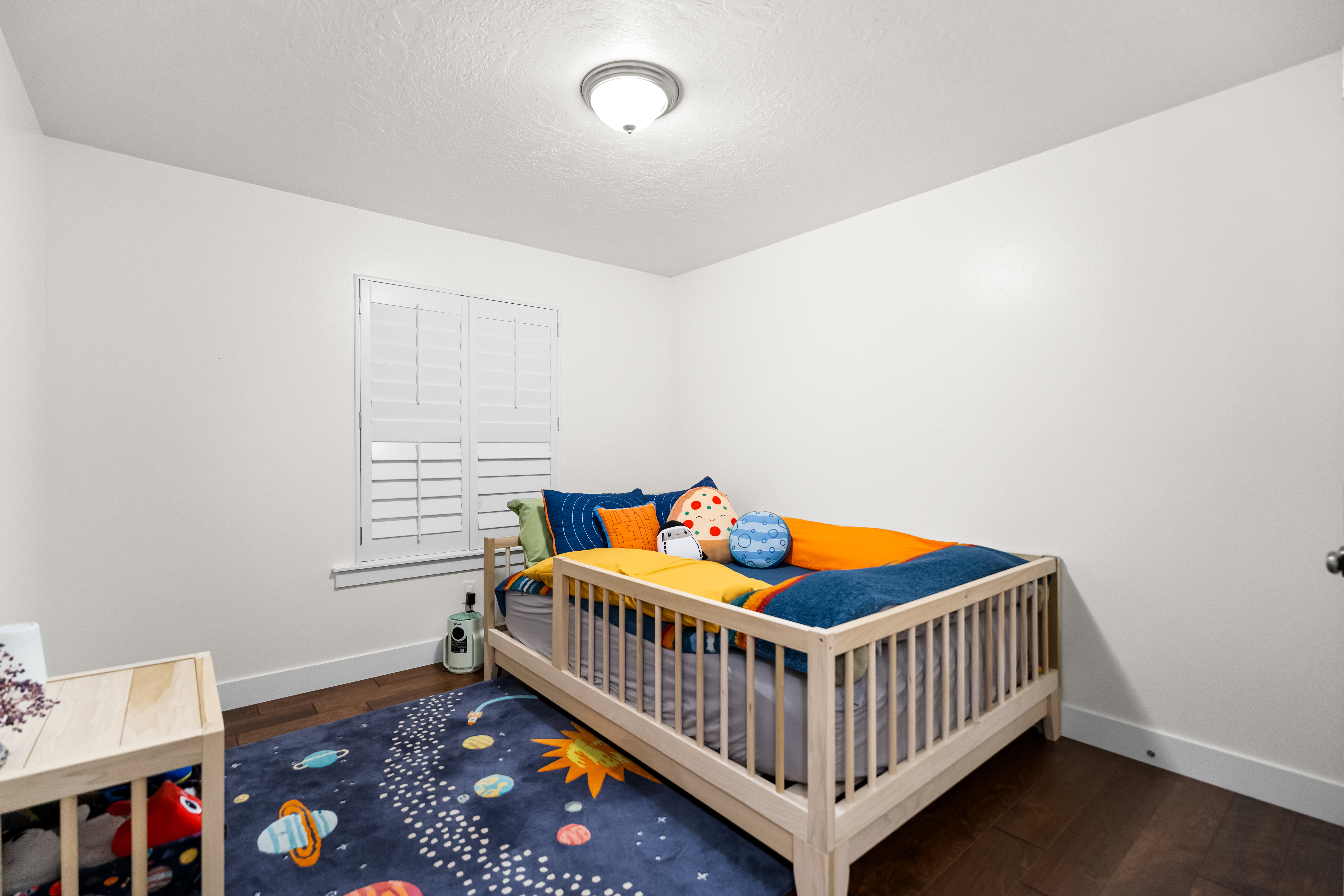 Room featuring dark wood-finish flooring and white walls