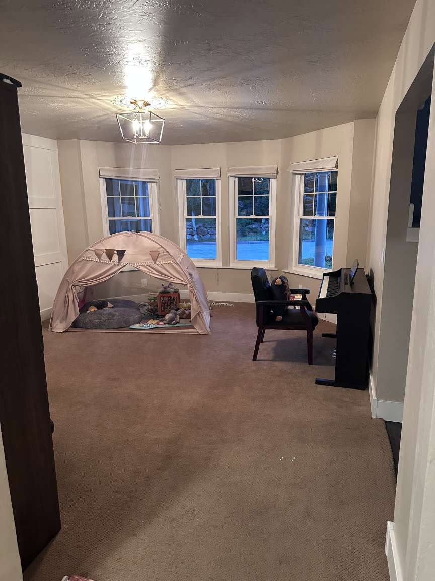 Bay window with four individual windows, recessed lighting, and carpeted flooring