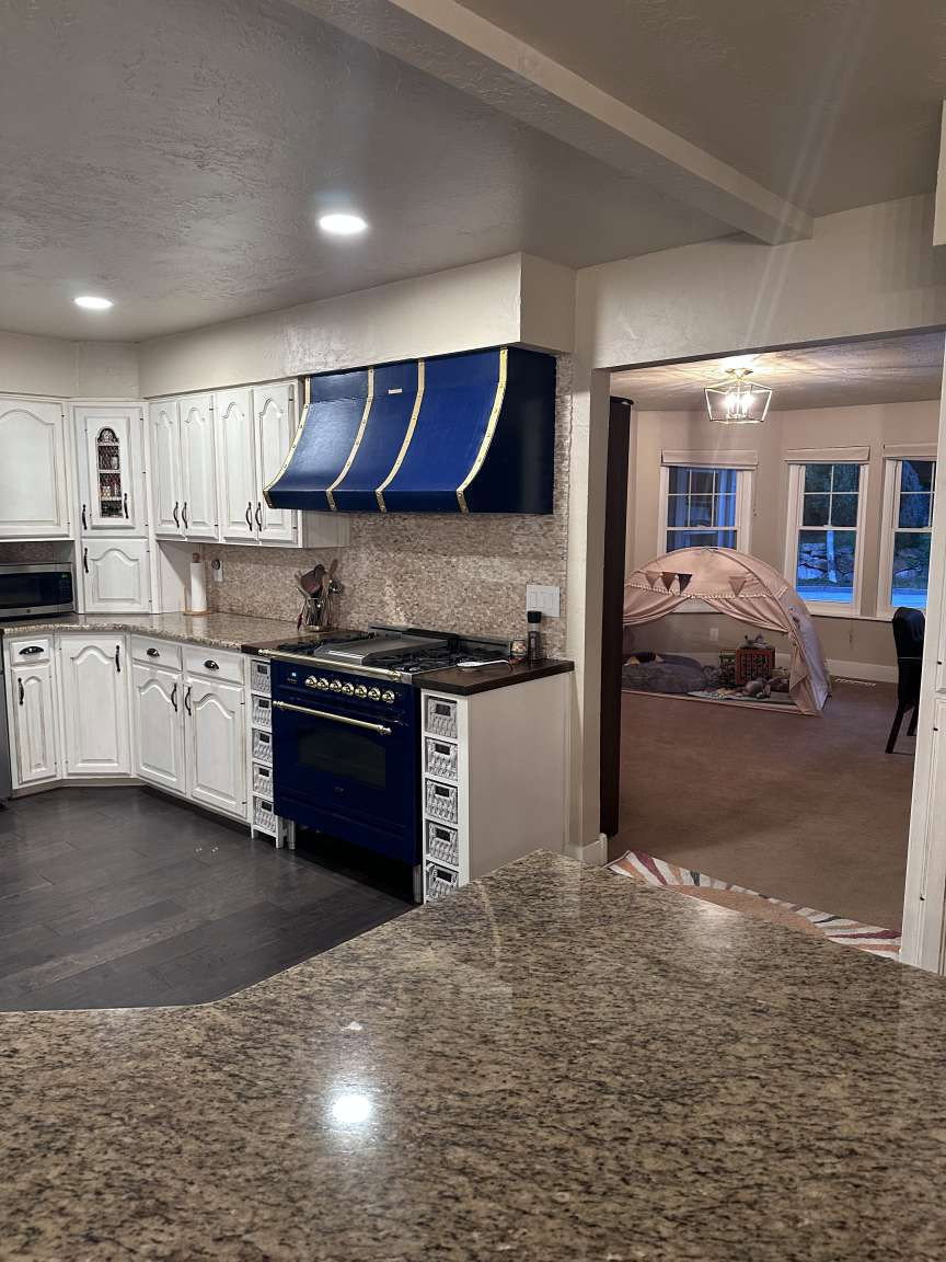 Kitchen featuring granite countertops and white cabinetry