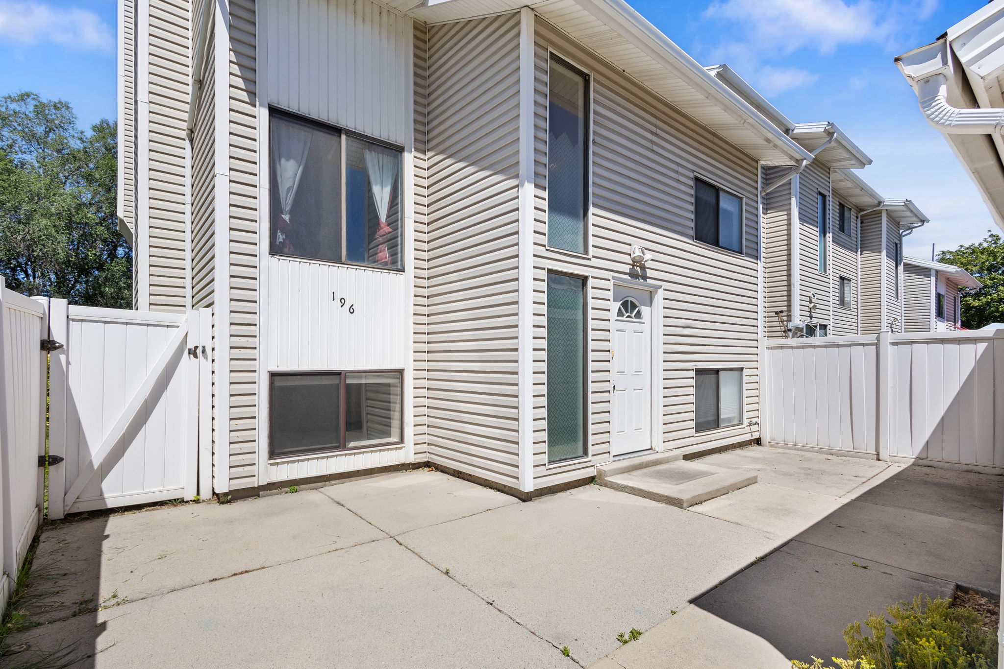 Exterior featuring horizontal siding, white trim, and a white front entry door