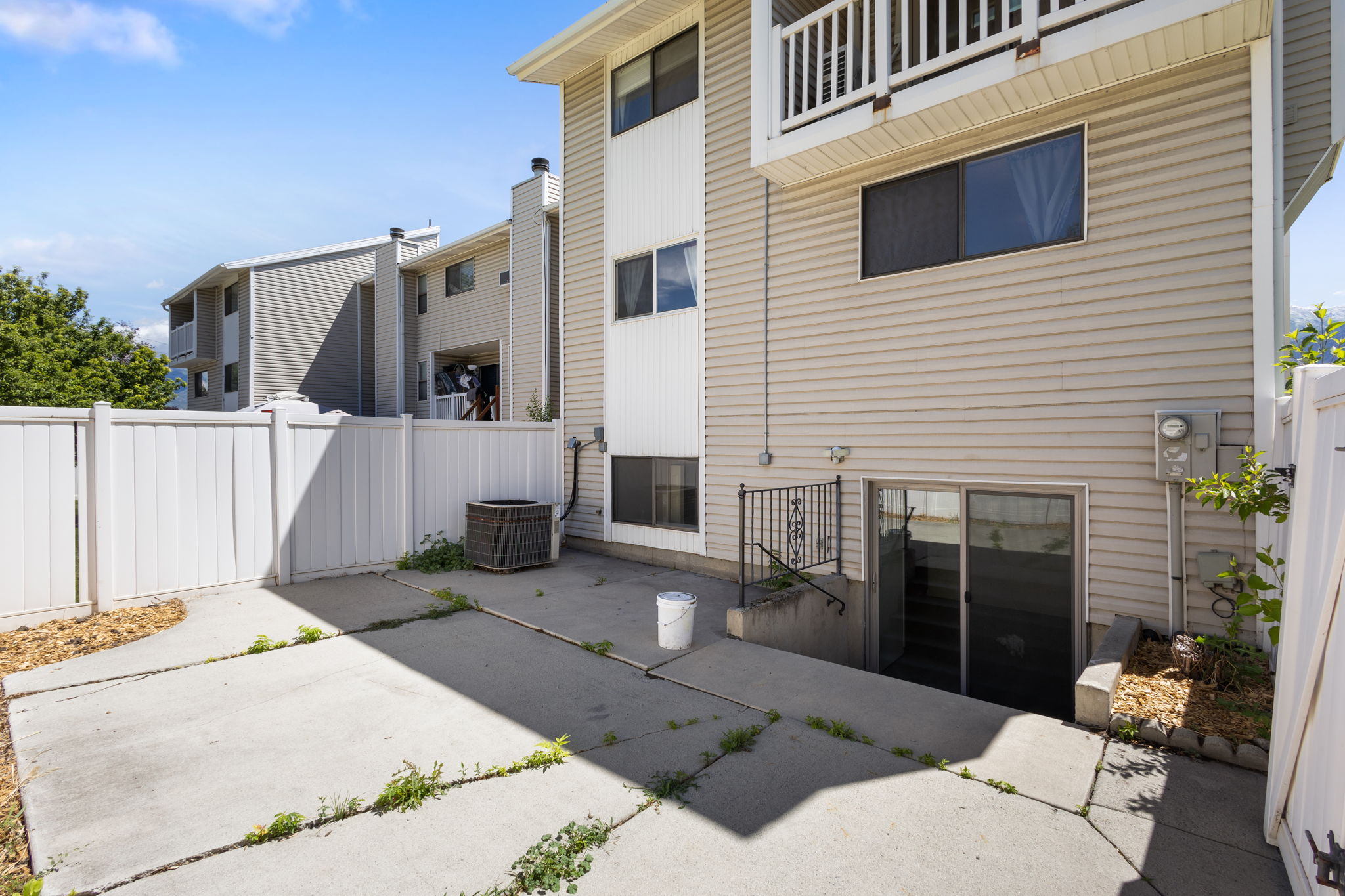 Rear exterior featuring beige siding and white trim