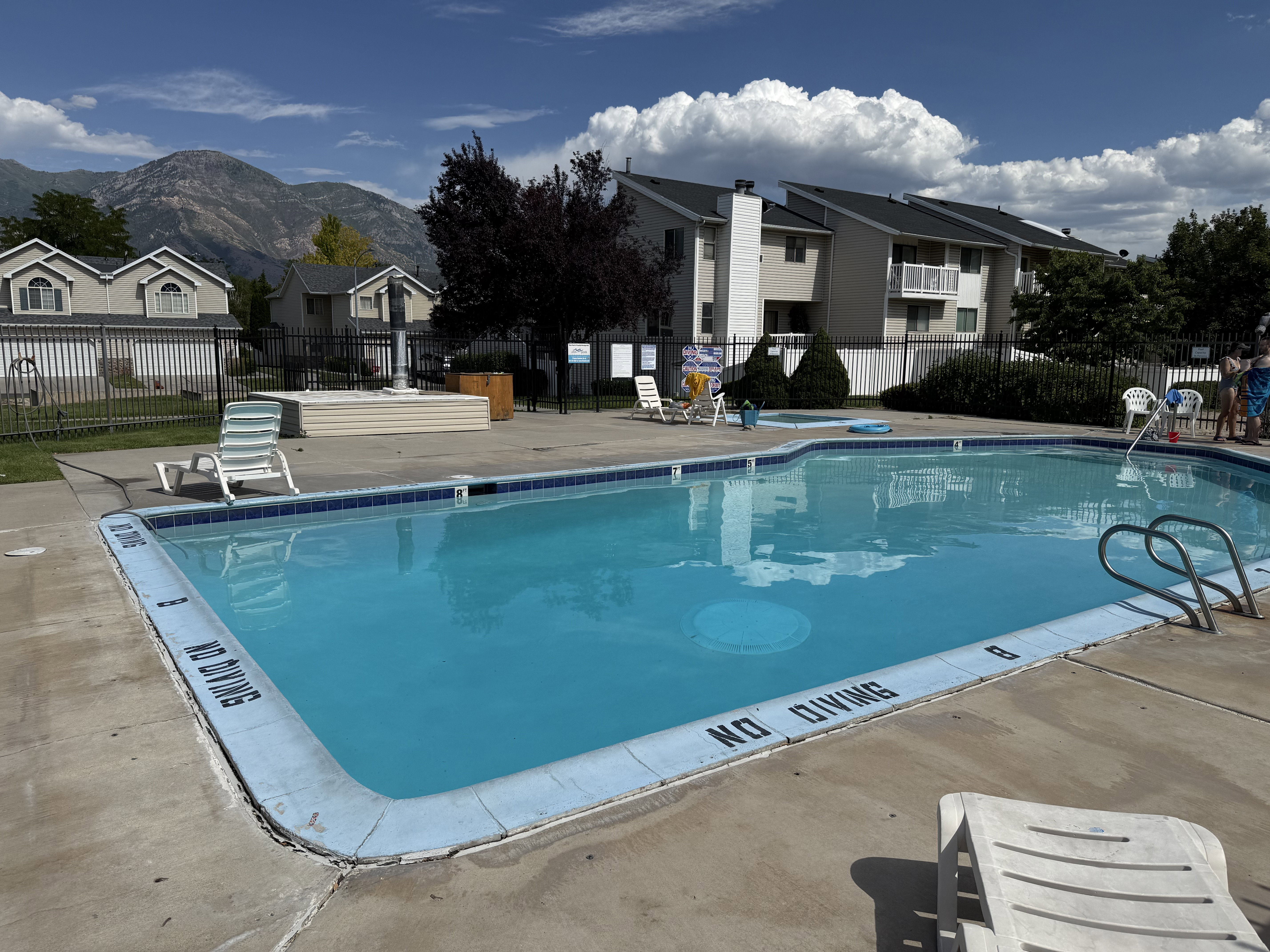 Community swimming pool with surrounding concrete deck