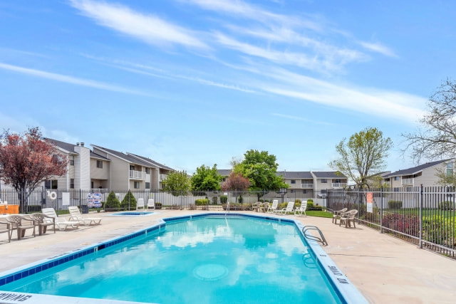 Community swimming pool with surrounding concrete decking