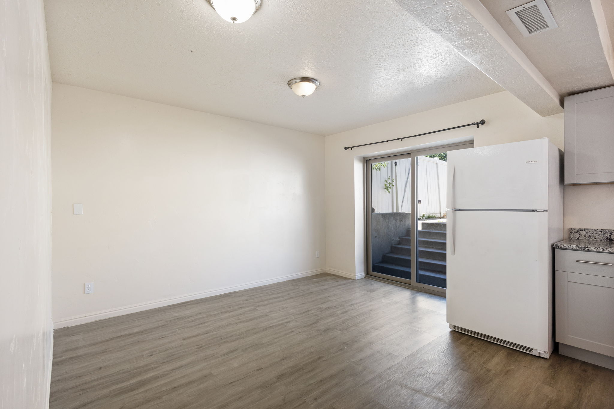 Interior space featuring wood-finish flooring, white walls, and recessed lighting