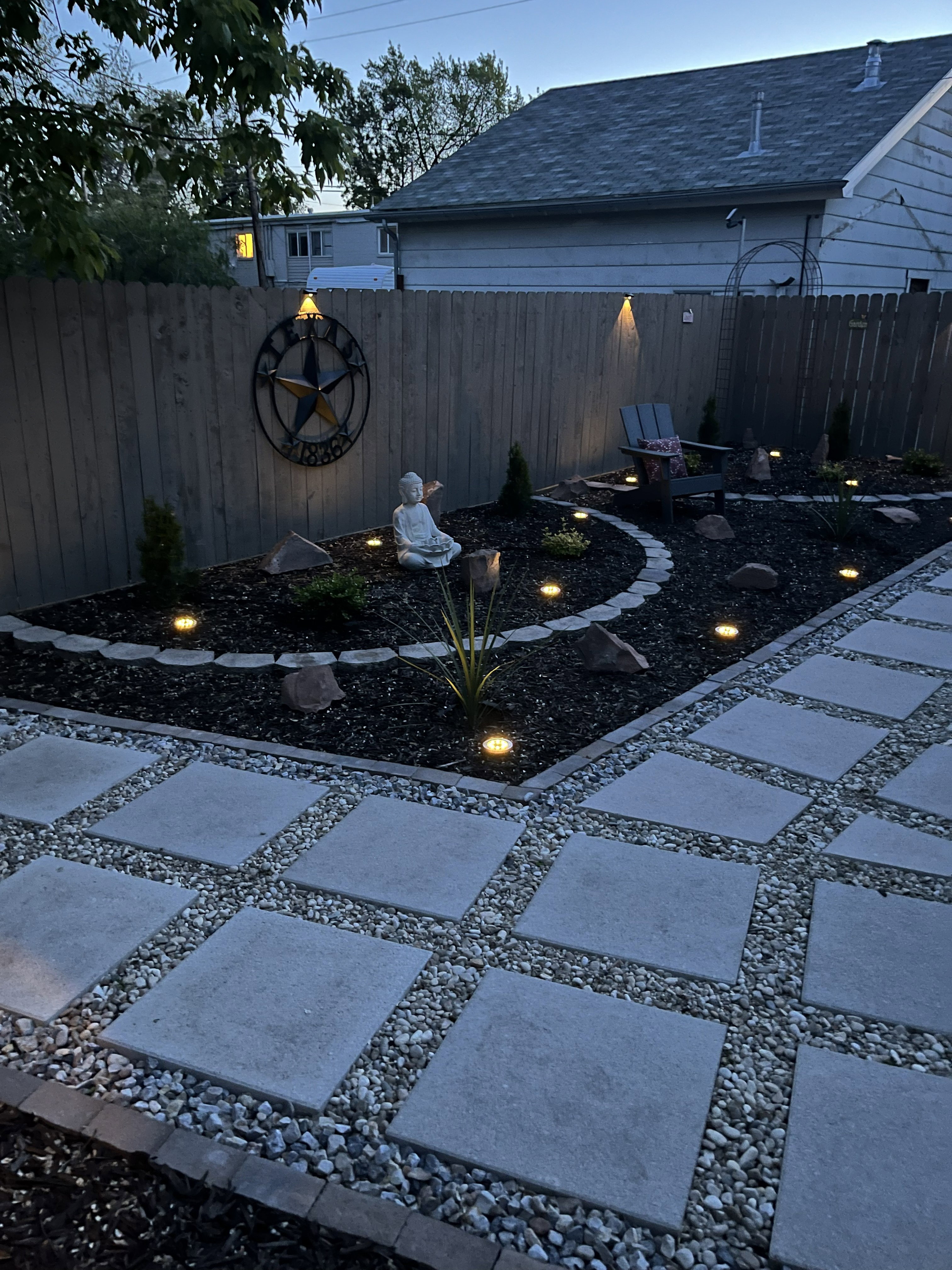 Peaceful zen-garden with lighting, gravel and pavers.