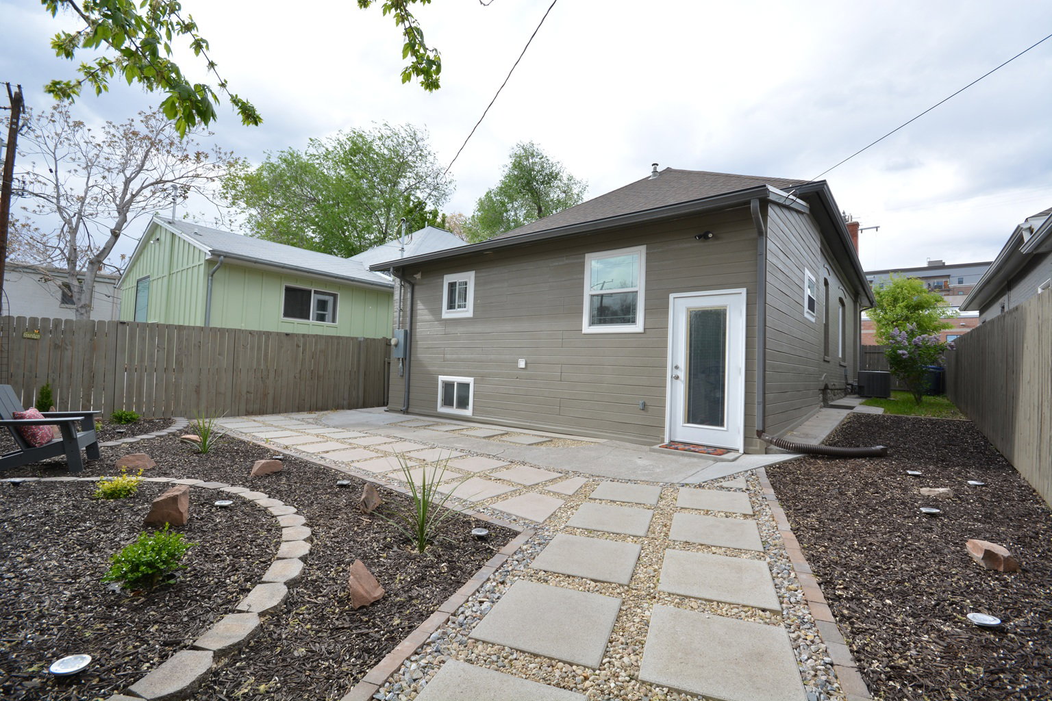 Nicely decorated and planted yard with pavers.