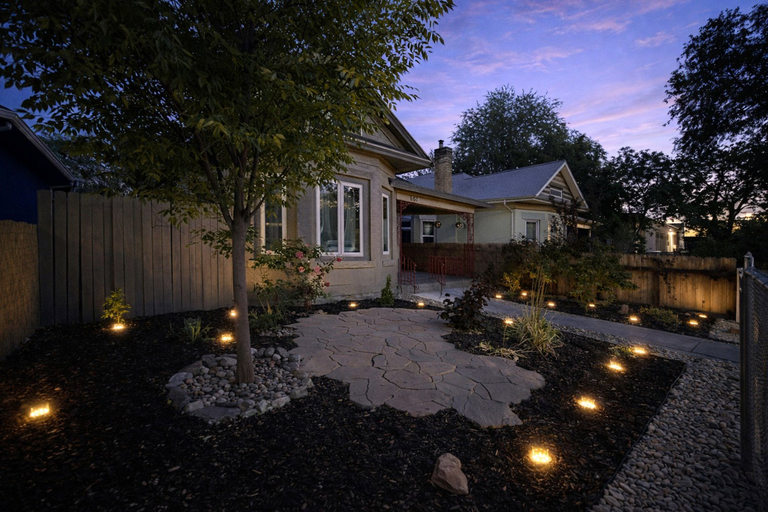 Low-maintenance front garden area with solar accent lighting.
