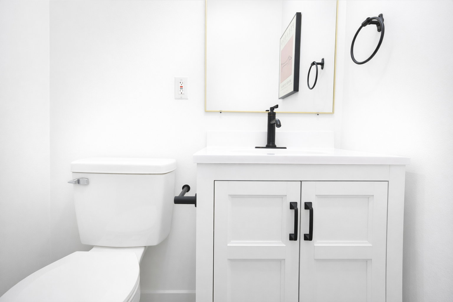Main level half bath, one of four total bathrooms.