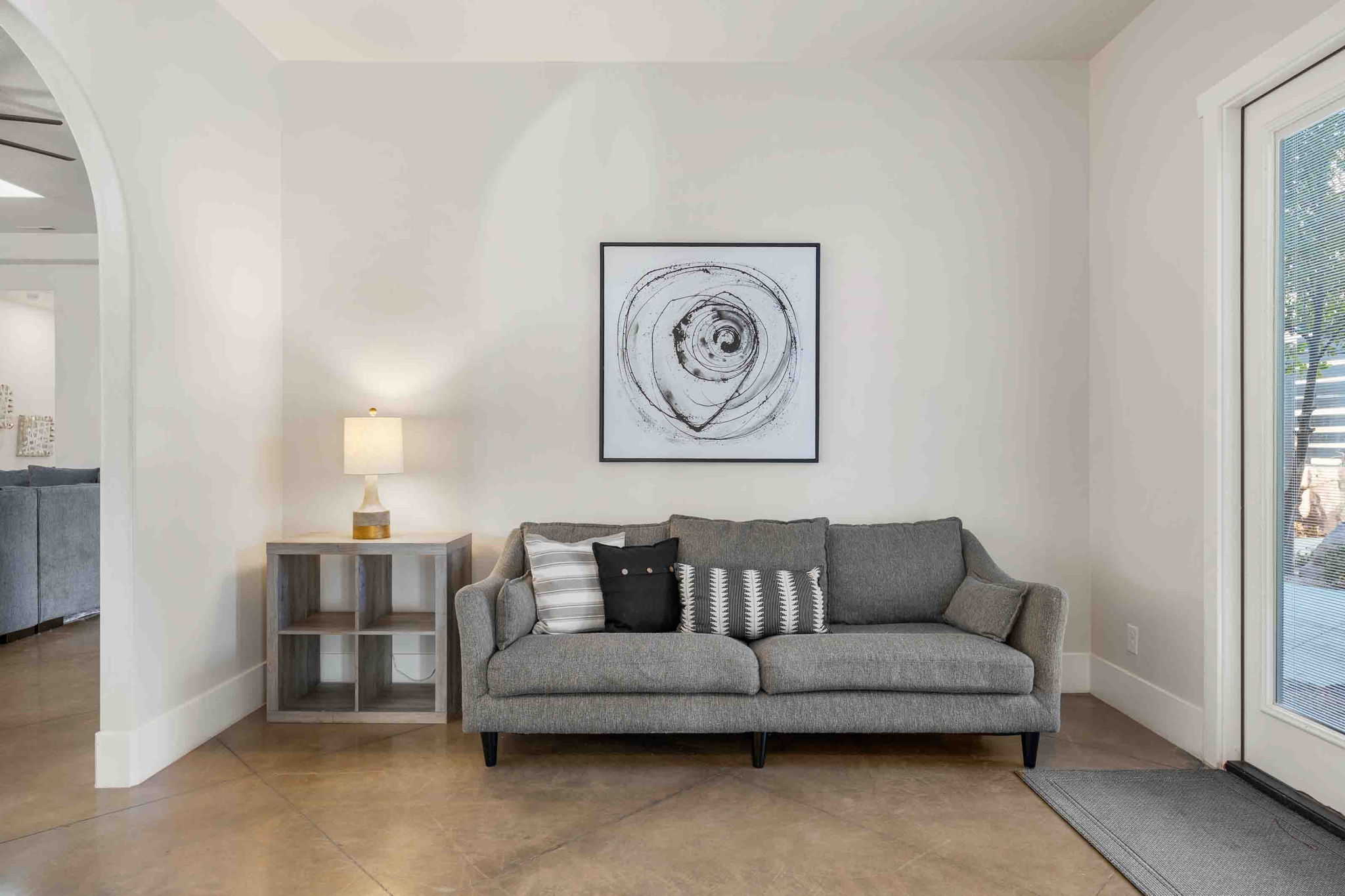 Smooth concrete flooring complements the white wall finishes