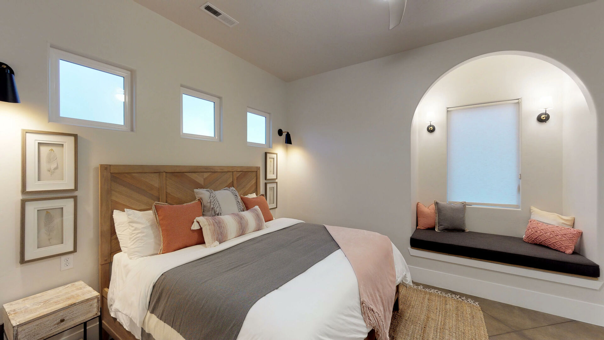 Bedroom featuring a vaulted ceiling, recessed lighting, and an arched window niche with a built-in bench