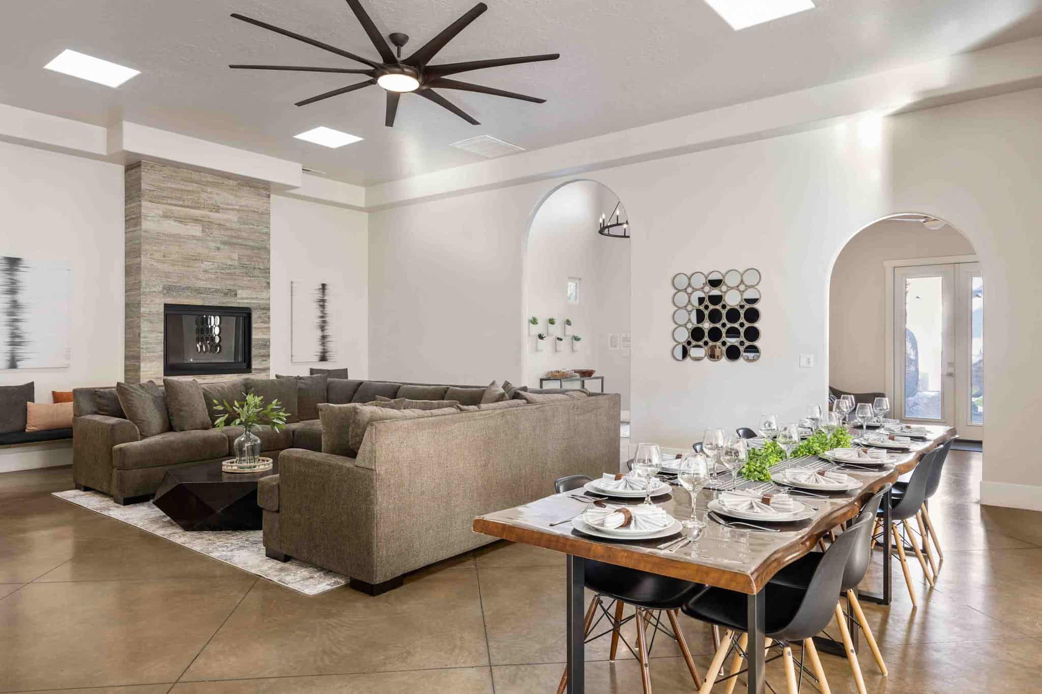 Spacious interior featuring high ceilings, multiple skylights, and polished concrete flooring