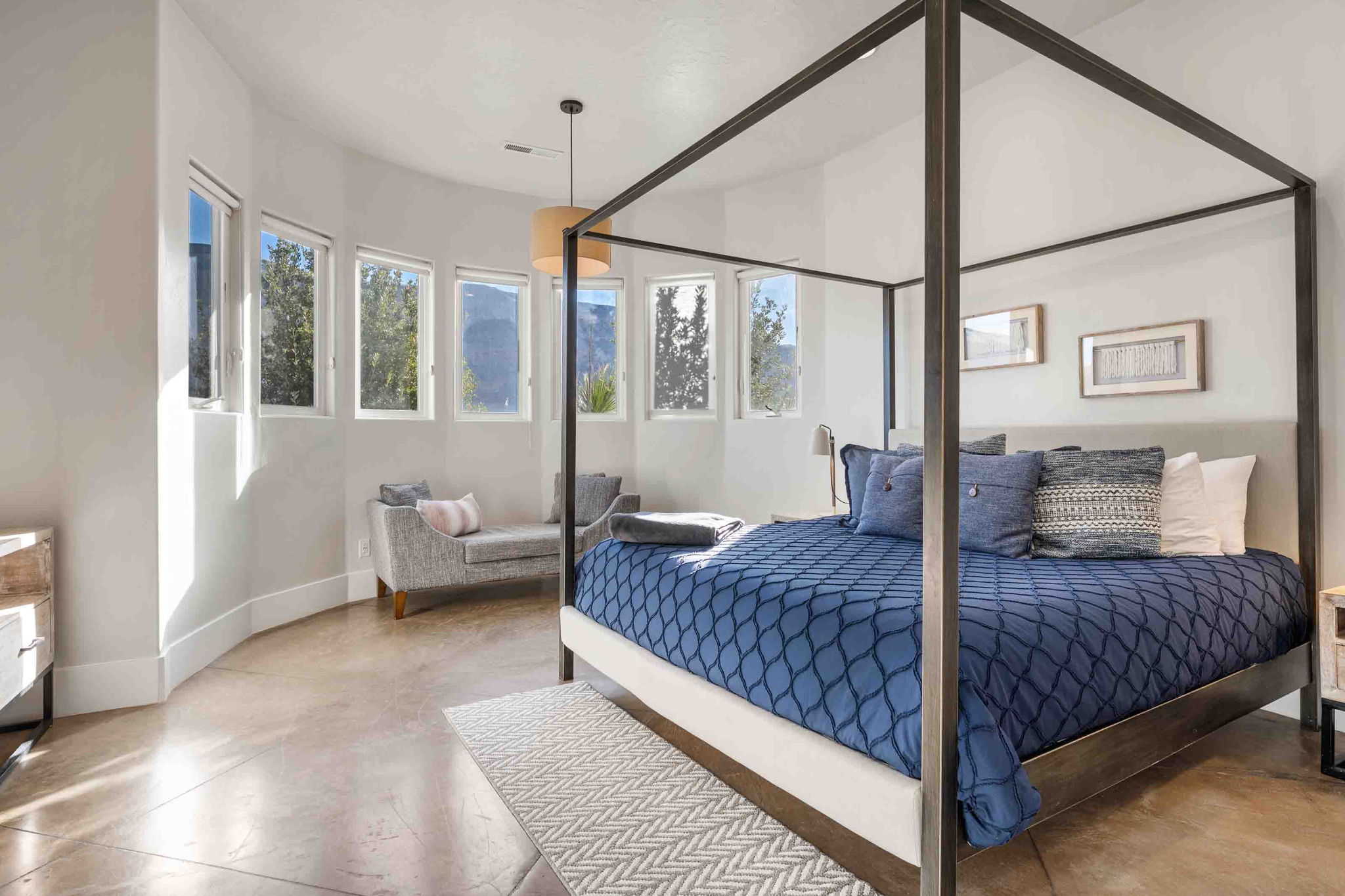 Spacious room with polished concrete flooring and a curved wall of multiple windows