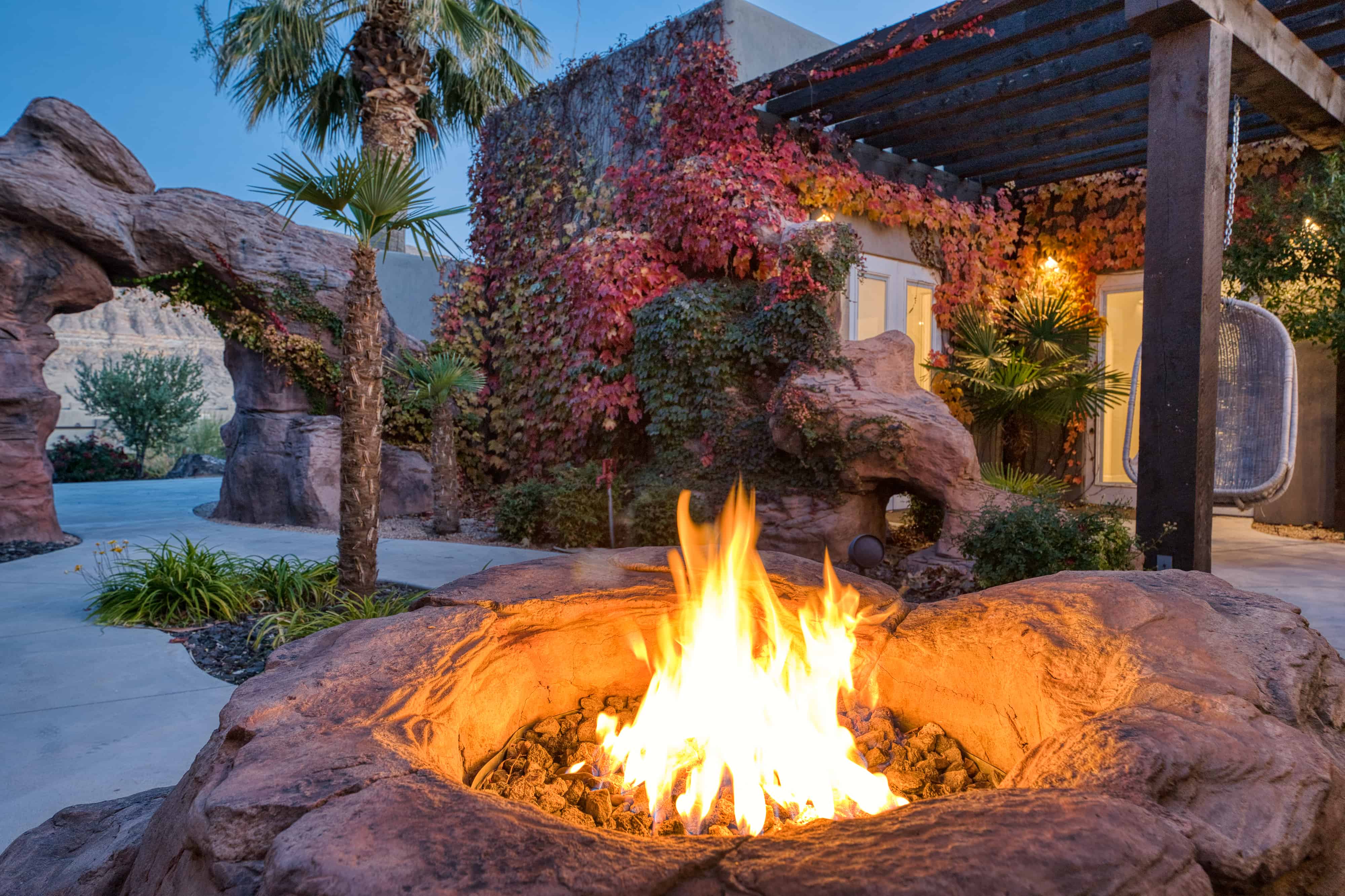 Outdoor fire pit with natural stone surround and integrated seating