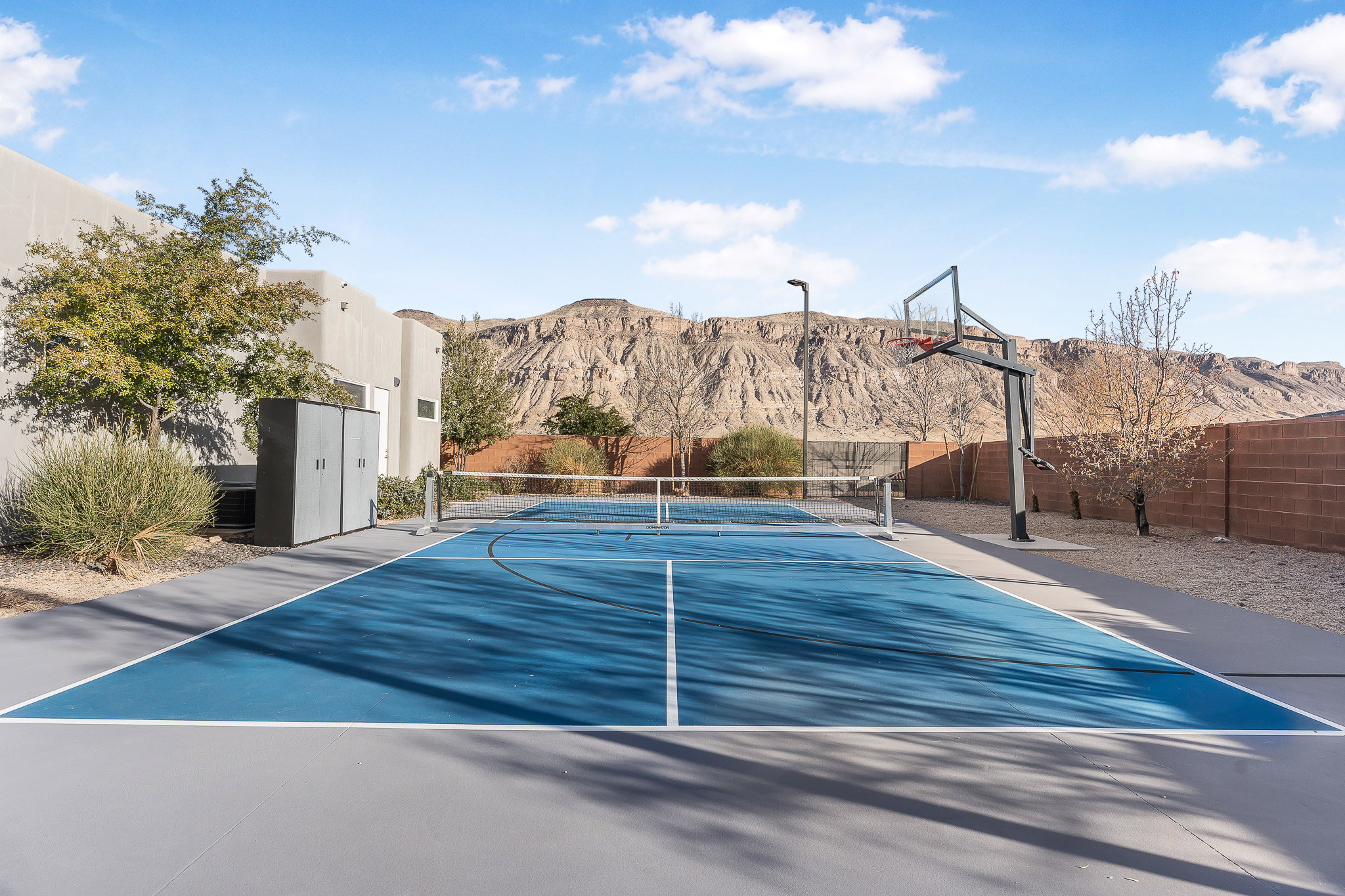 Multi-sport court featuring a blue playing surface and white boundary lines