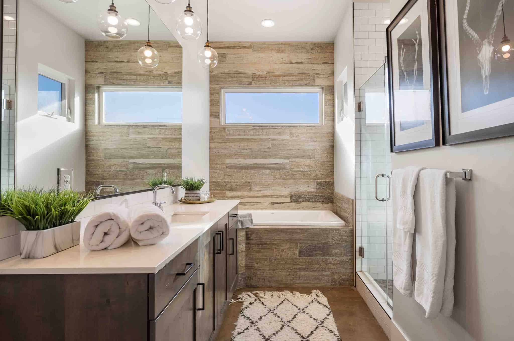 Contemporary bathroom featuring a spacious double vanity with dark wood cabinetry and light-toned countertops