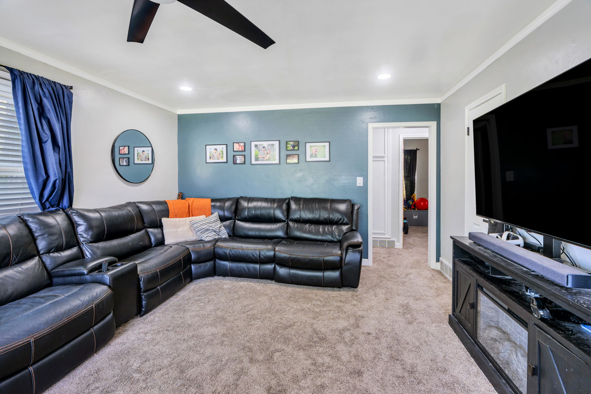 Carpeted living space featuring recessed lighting and a ceiling fan