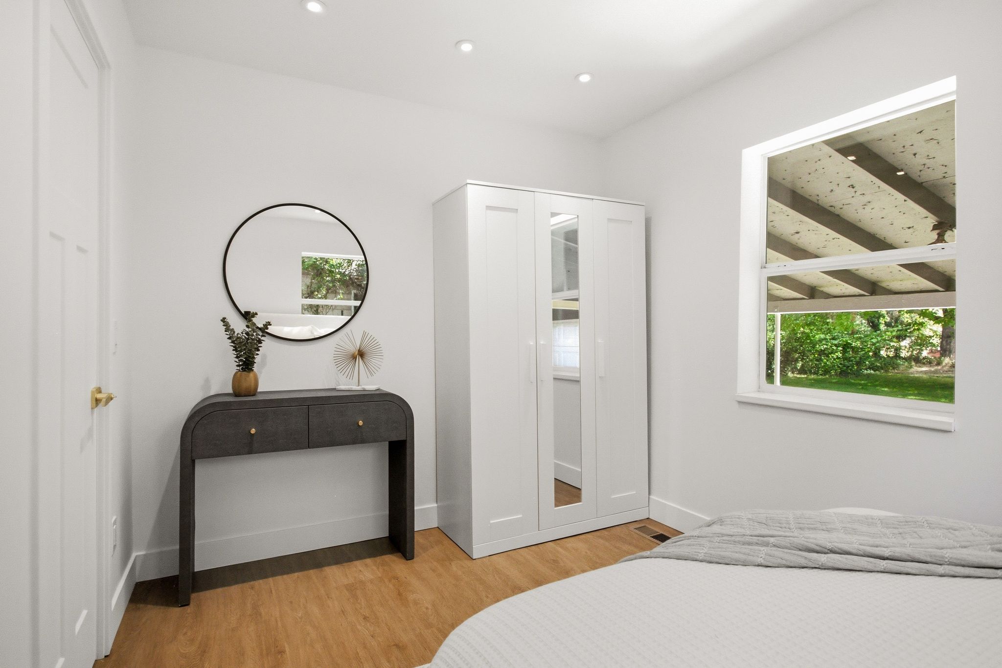 Bright interior space featuring wood-finish flooring, recessed lighting, and a white framed window