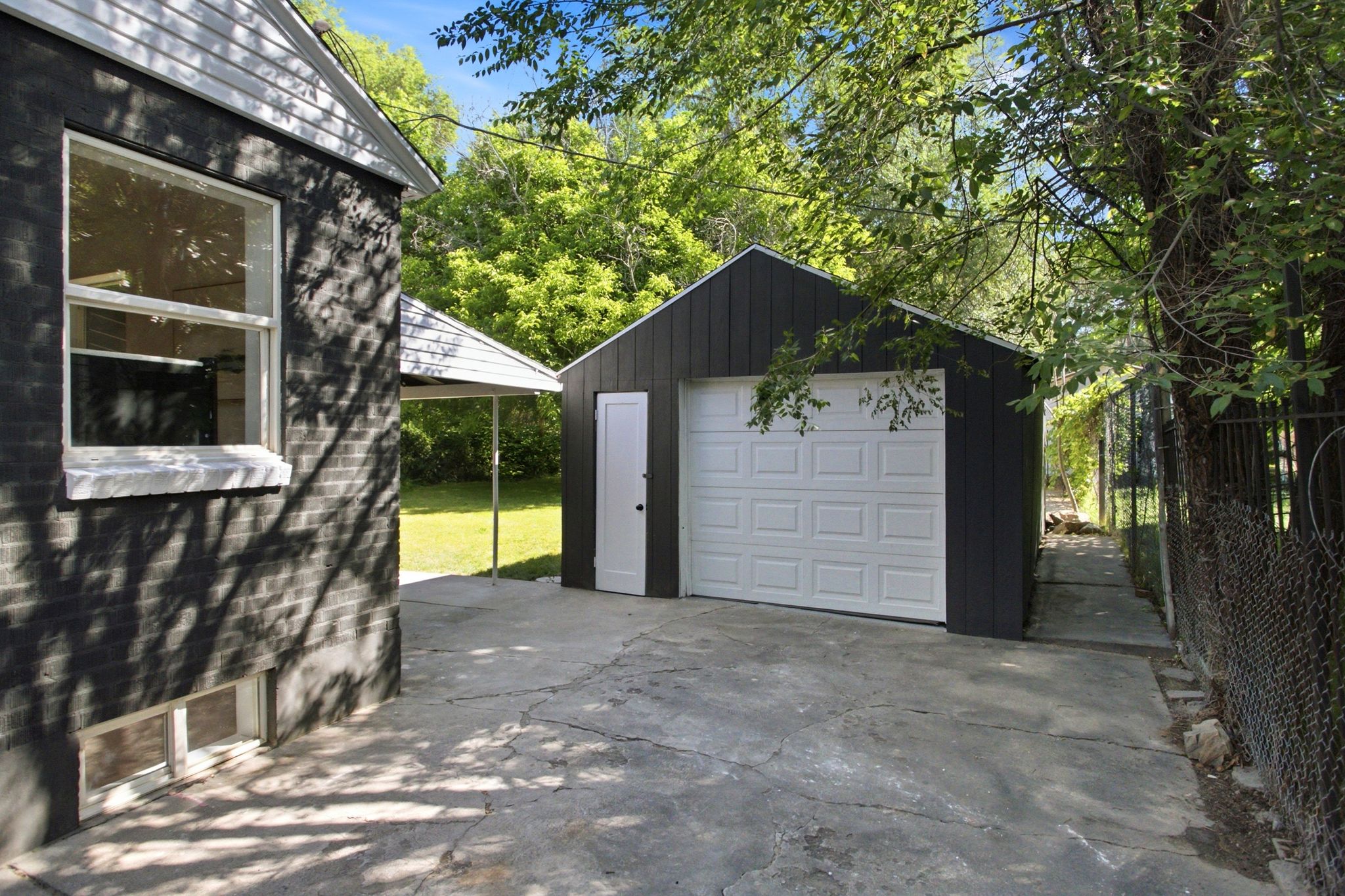 Detached garage with a white panel door and an additional side entry door