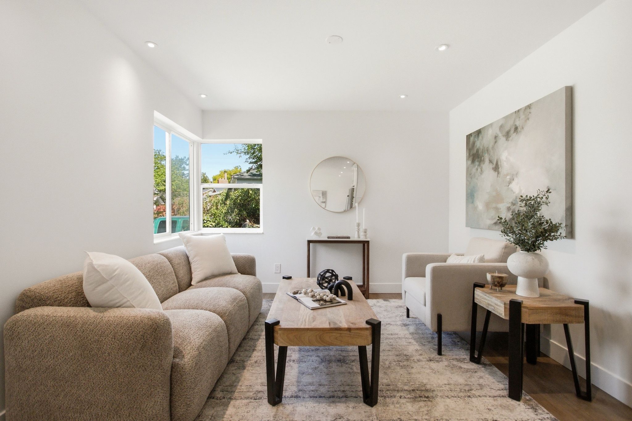 Living area with recessed lighting and wood-finish flooring