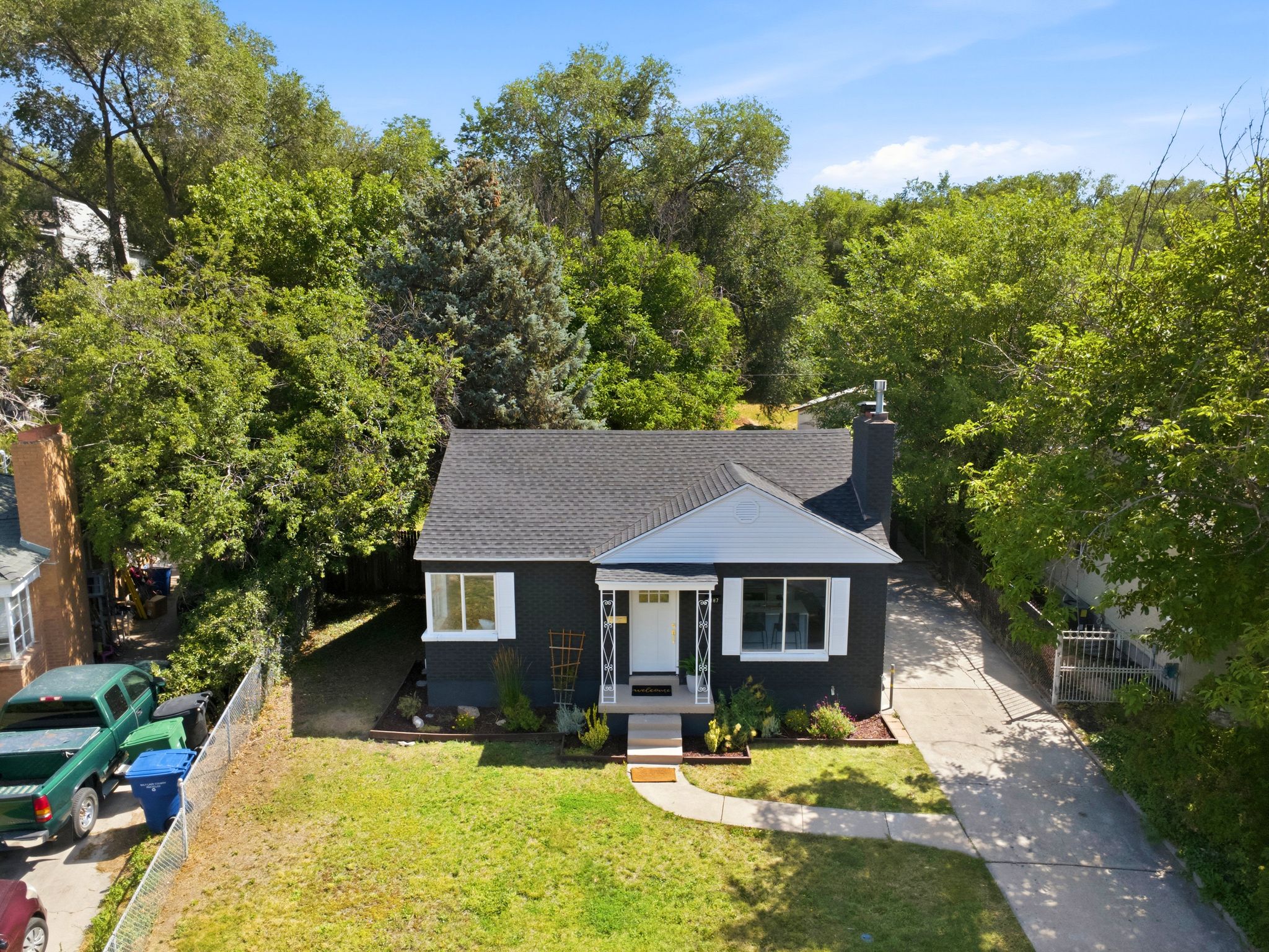 Single-story residence featuring a dark exterior with white trim
