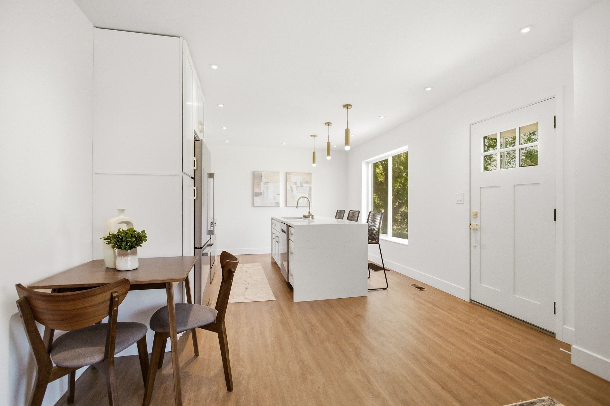 Open concept living area featuring wood-finish flooring