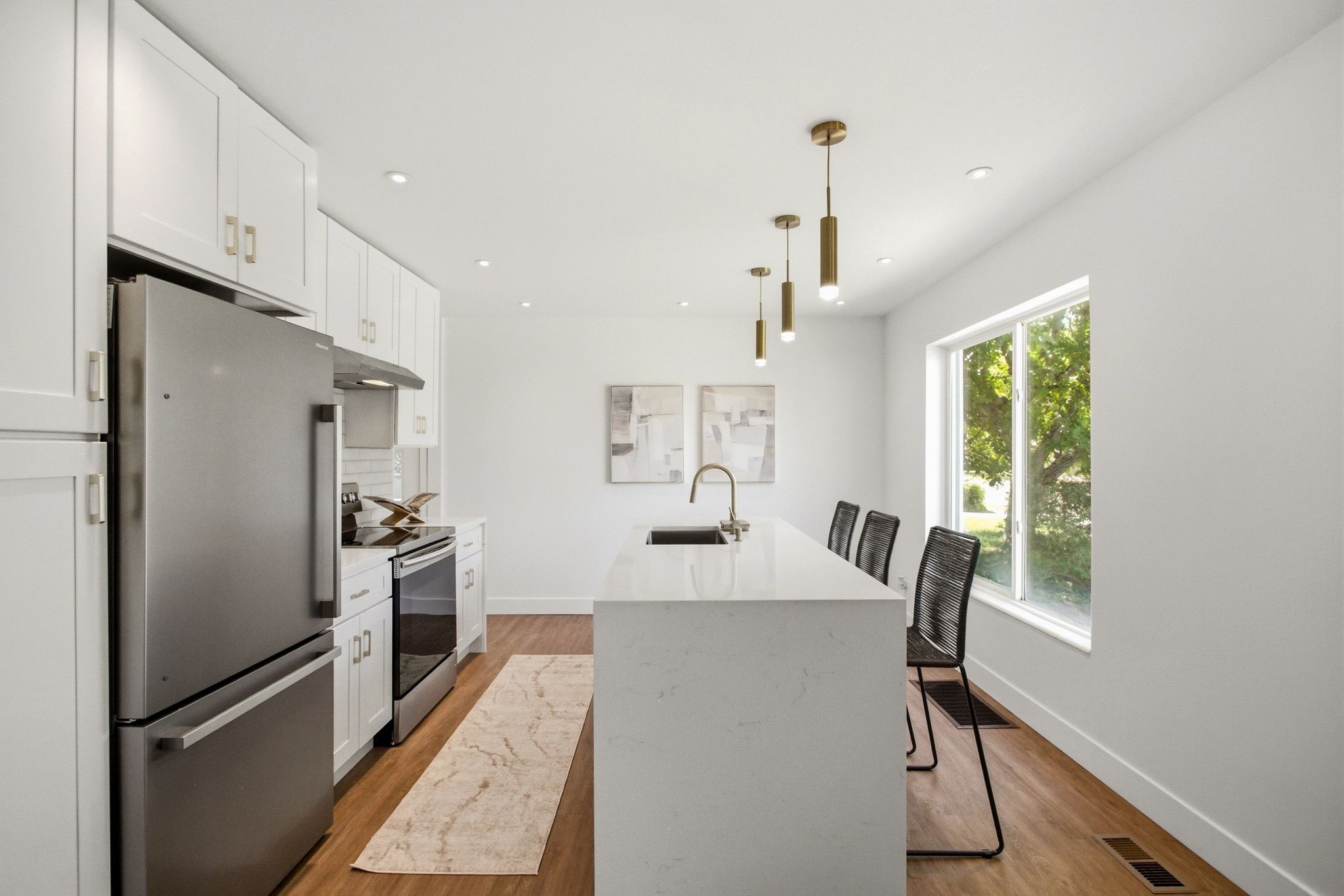 Modern kitchen with white cabinetry and gold-tone hardware