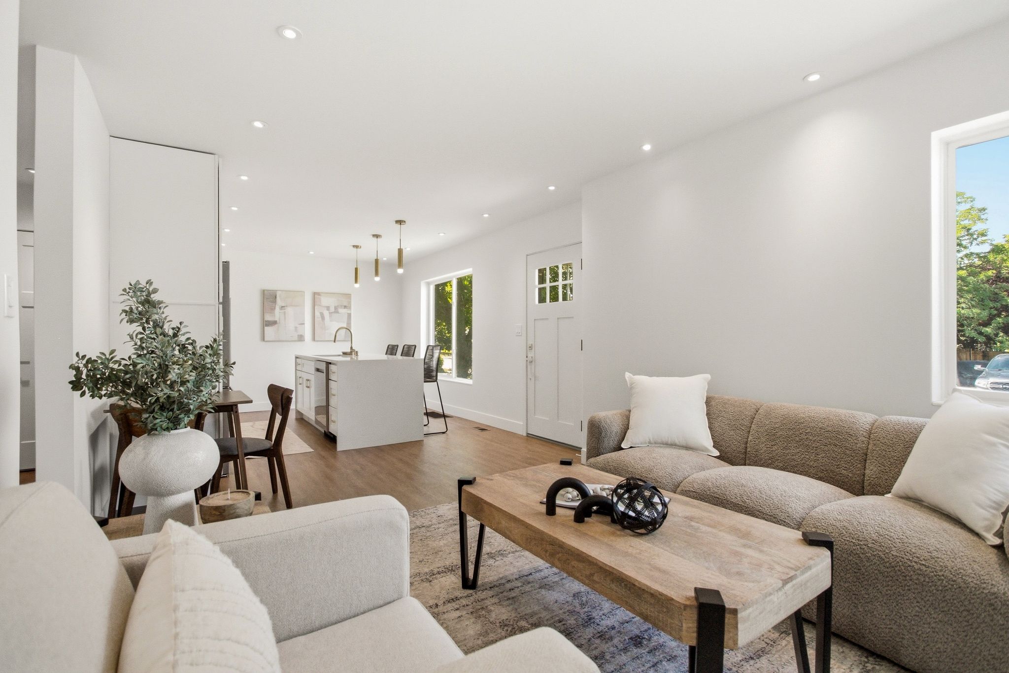 Open-concept living area featuring wood-finish flooring throughout