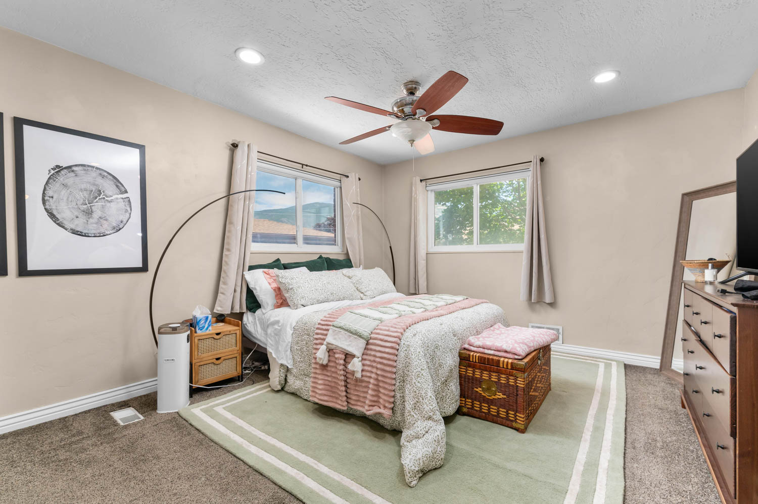 Carpeted bedroom featuring recessed lighting, a ceiling fan, and two windows